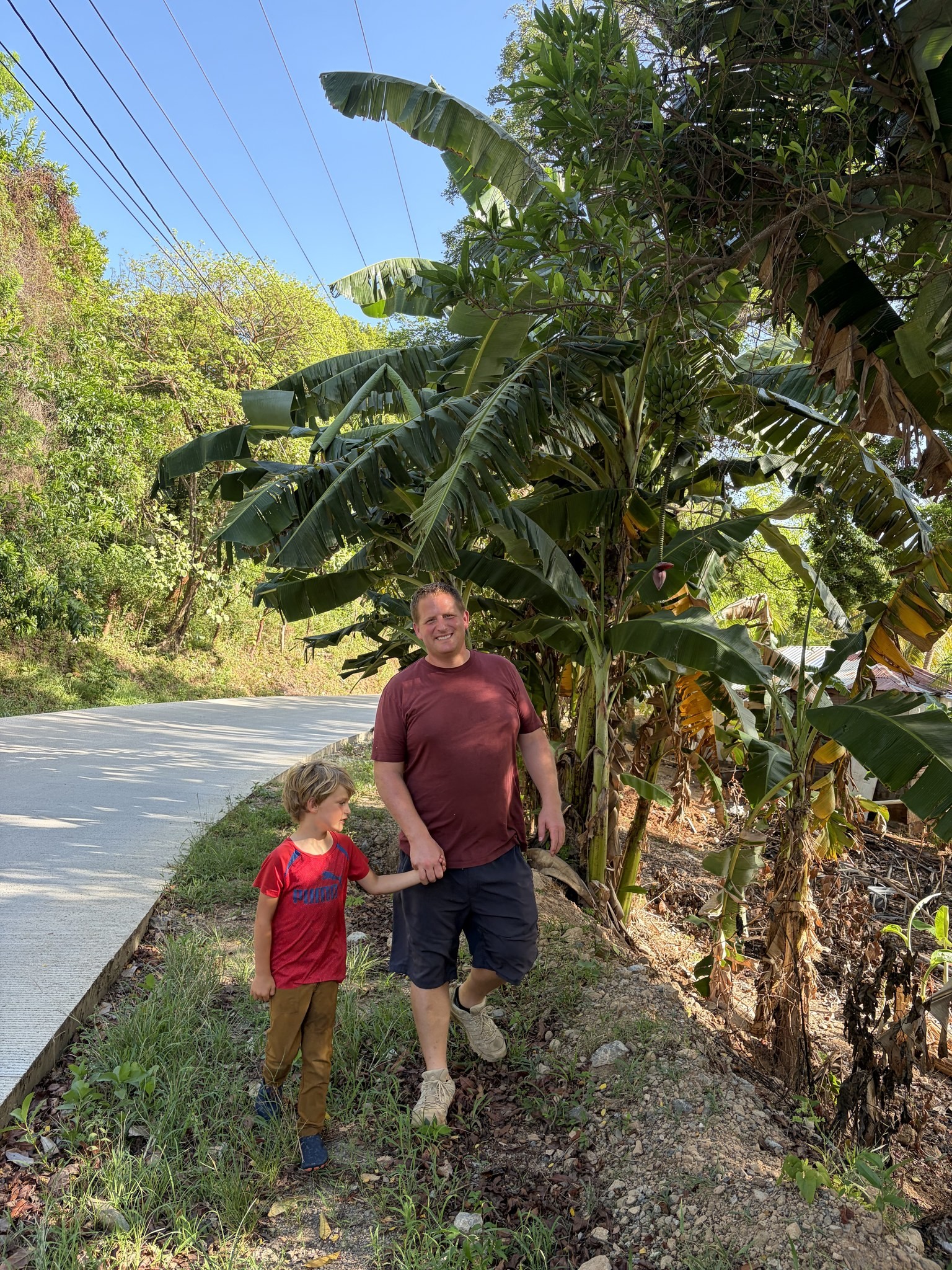 Preston and Hyrum walking a road in Honduras