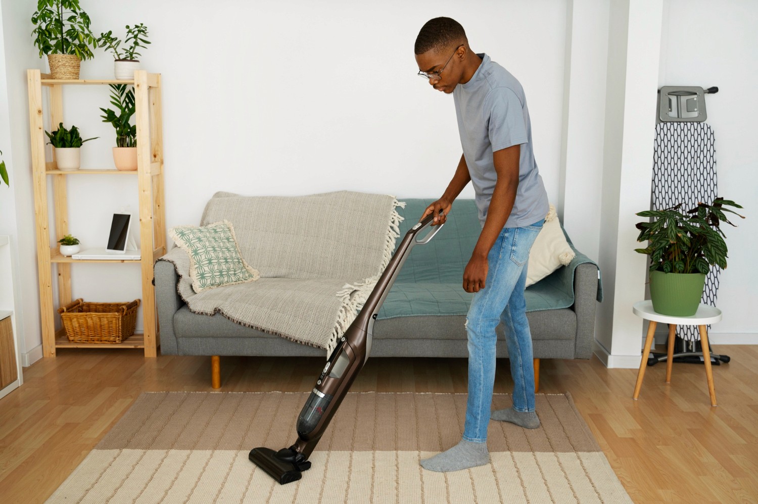 Person cleaning the floor with a green microfiber mop, wearing beige pants and sneakers, showcasing a modern and efficient cleaning method in an office setting.