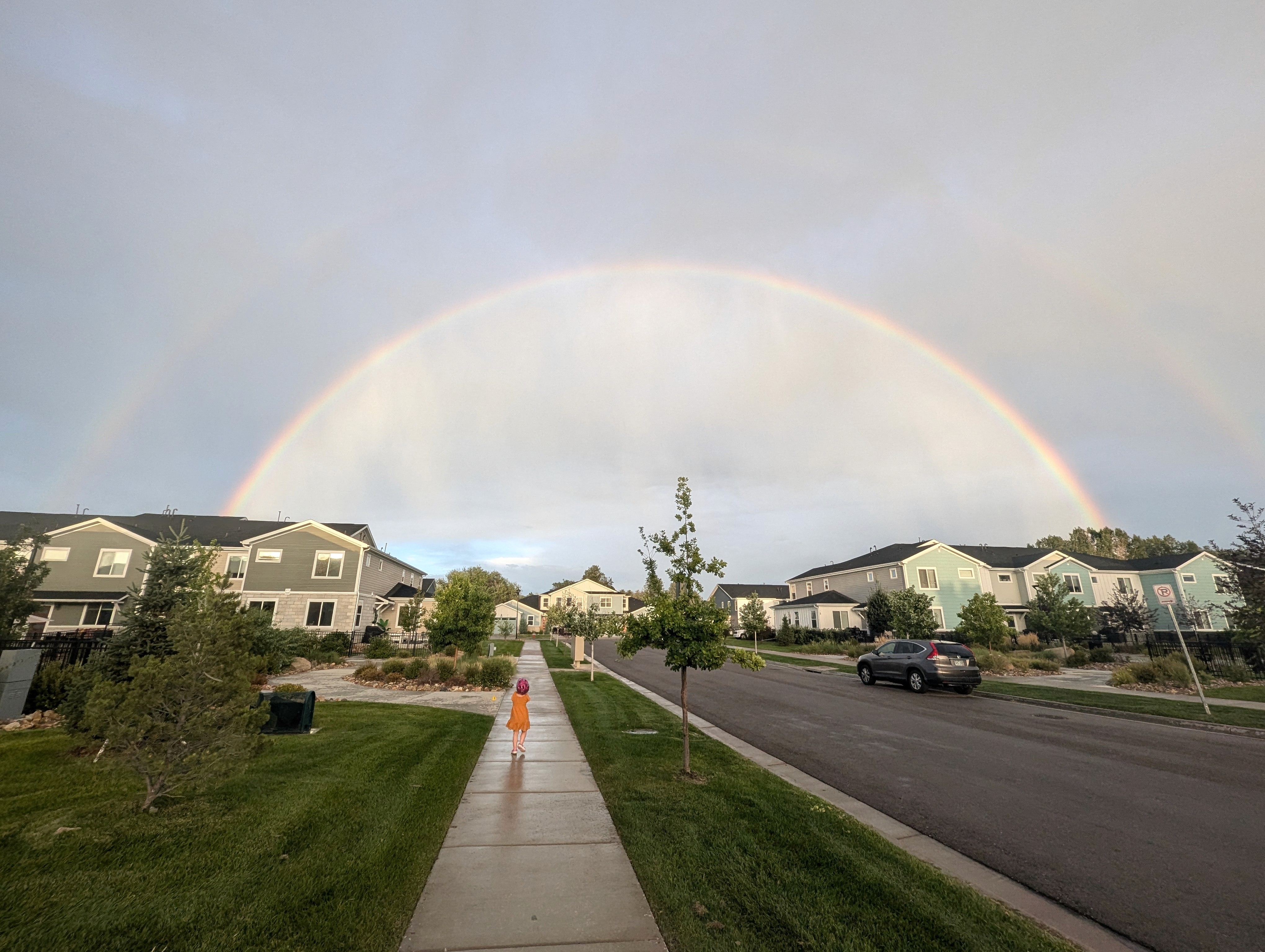 A girl looking at a rainbow