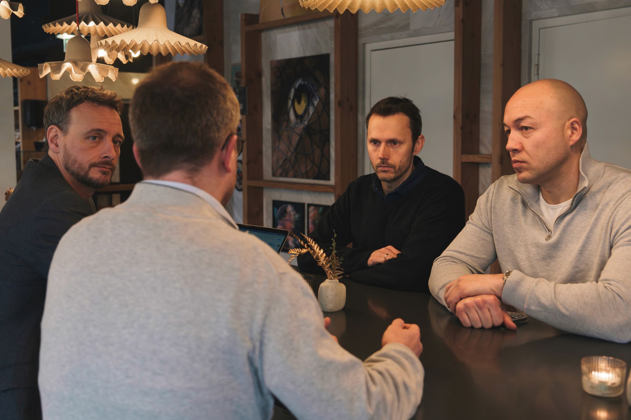 woman in black long sleeve shirt sitting beside woman in gray sweater