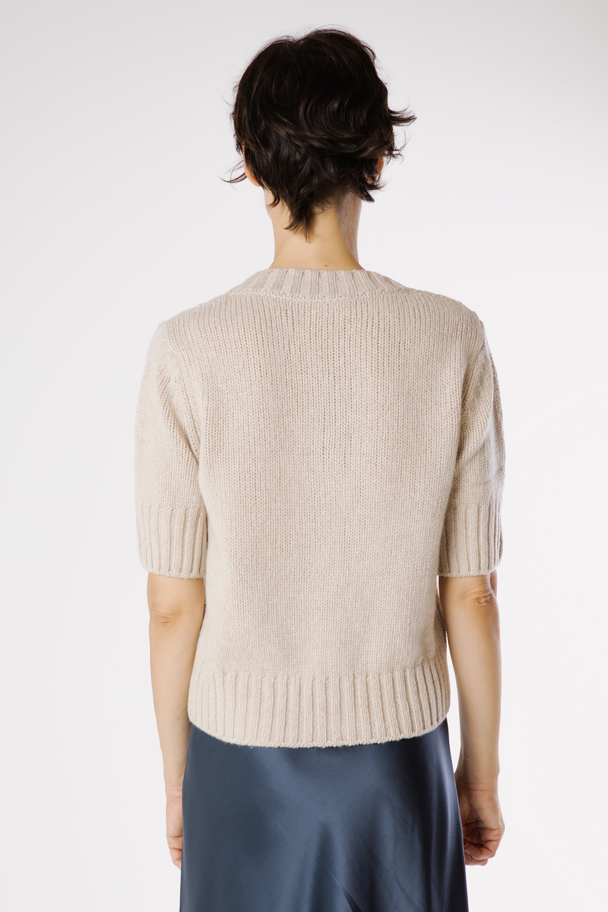 Back view of Artemisa Cashmere Cardigan Sphinx showcasing clean silhouette and fine knit texture.