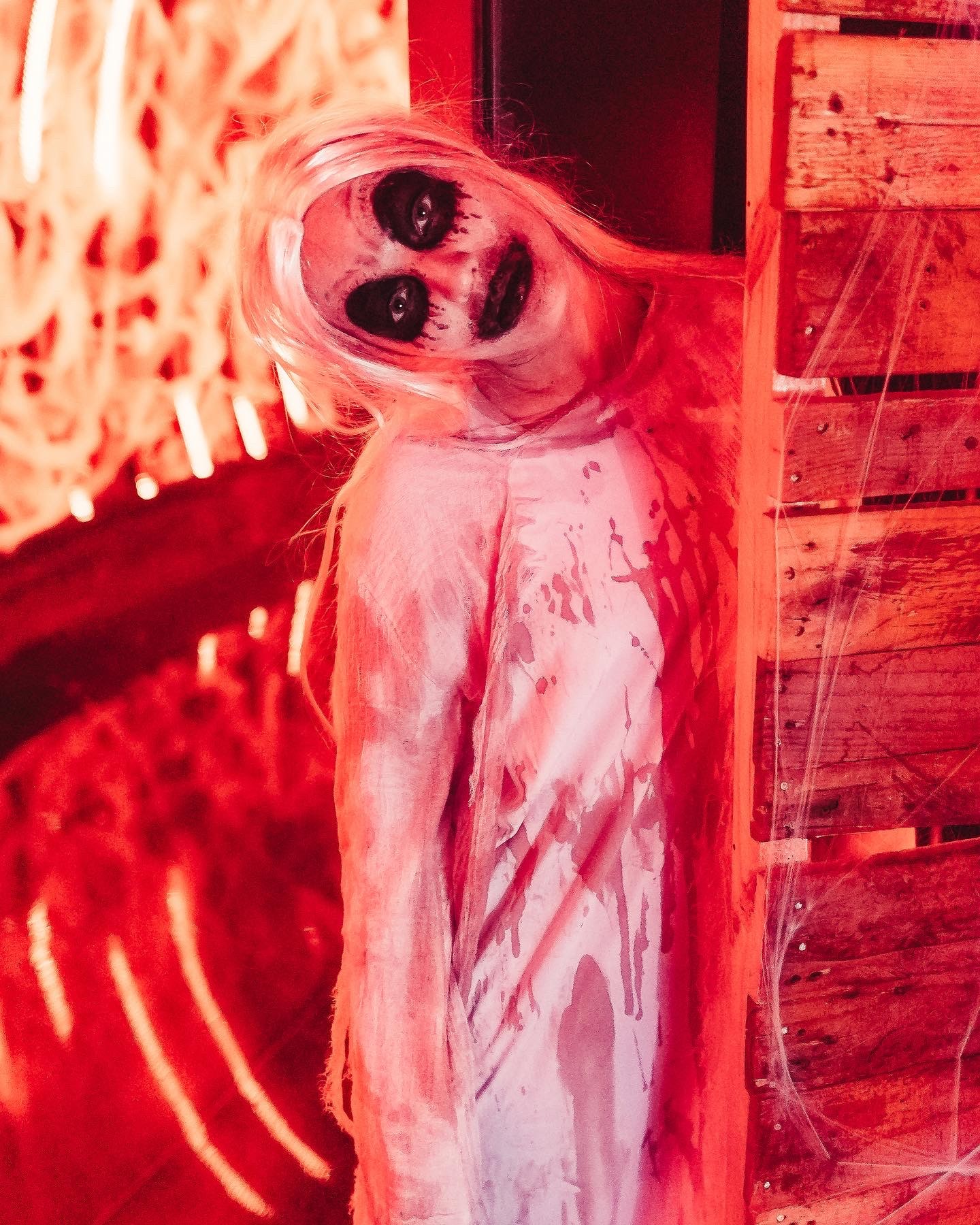 Ghost girl performer in white blood stained costume with black horror makeup at Stage nightclub Halloween event Dubai