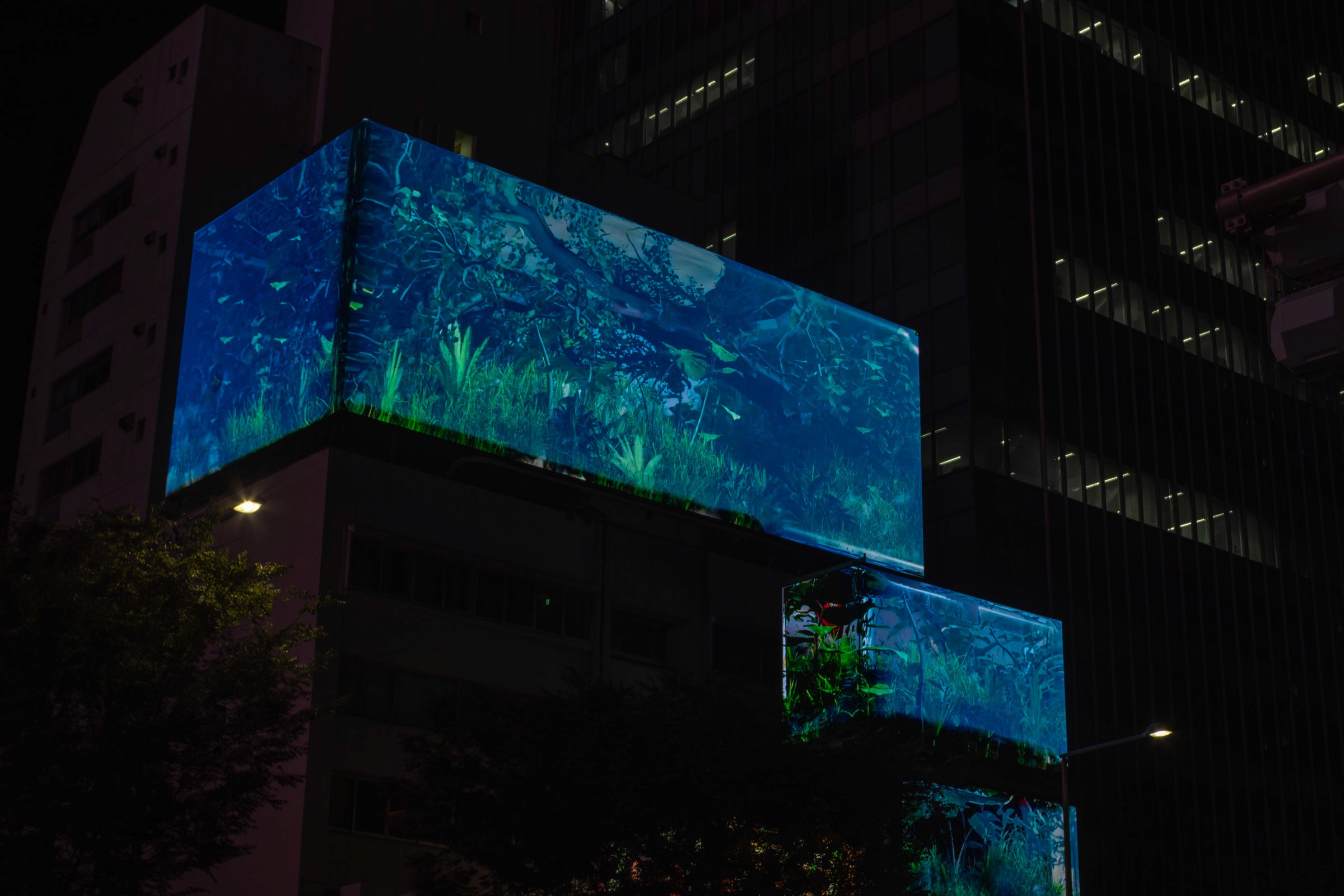 Night photograph of Tokyo architecture shot with the Zuiko 28mm, showing deep depth of field characteristic of a stopped-down aperture