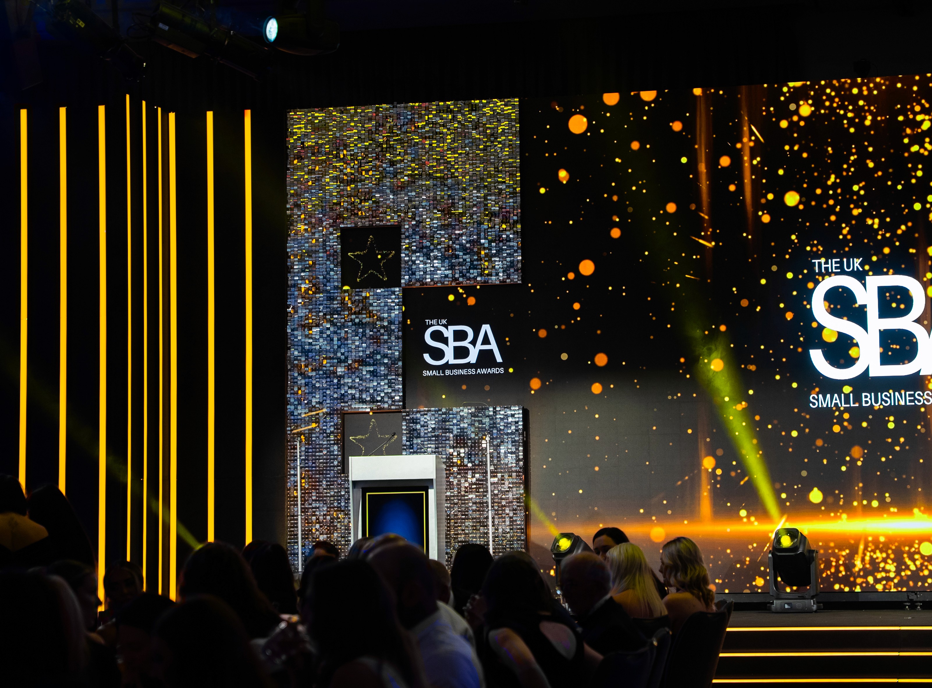UK Small Business Awards 2025 stage featuring a large LED video wall, illuminated steps, custom scenic panels and event lighting in Birmingham.