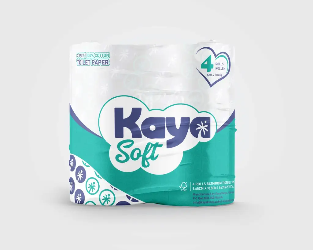 A person in a white outfit sits on a round stool in a spacious, minimalist room. The wall is covered with framed photos surrounding a large screen, creating a serene, contemplative atmosphere