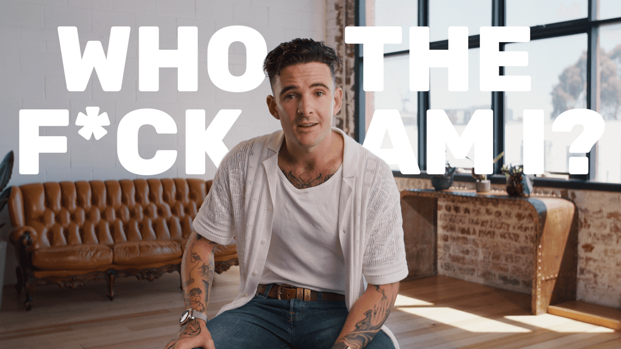 Tom Noske wearing a white shirt with a couch in the background