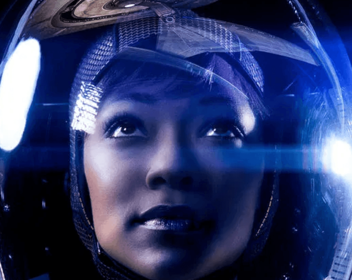 Close-up of a yellow tennis ball sitting on a green court, positioned near the white center line.