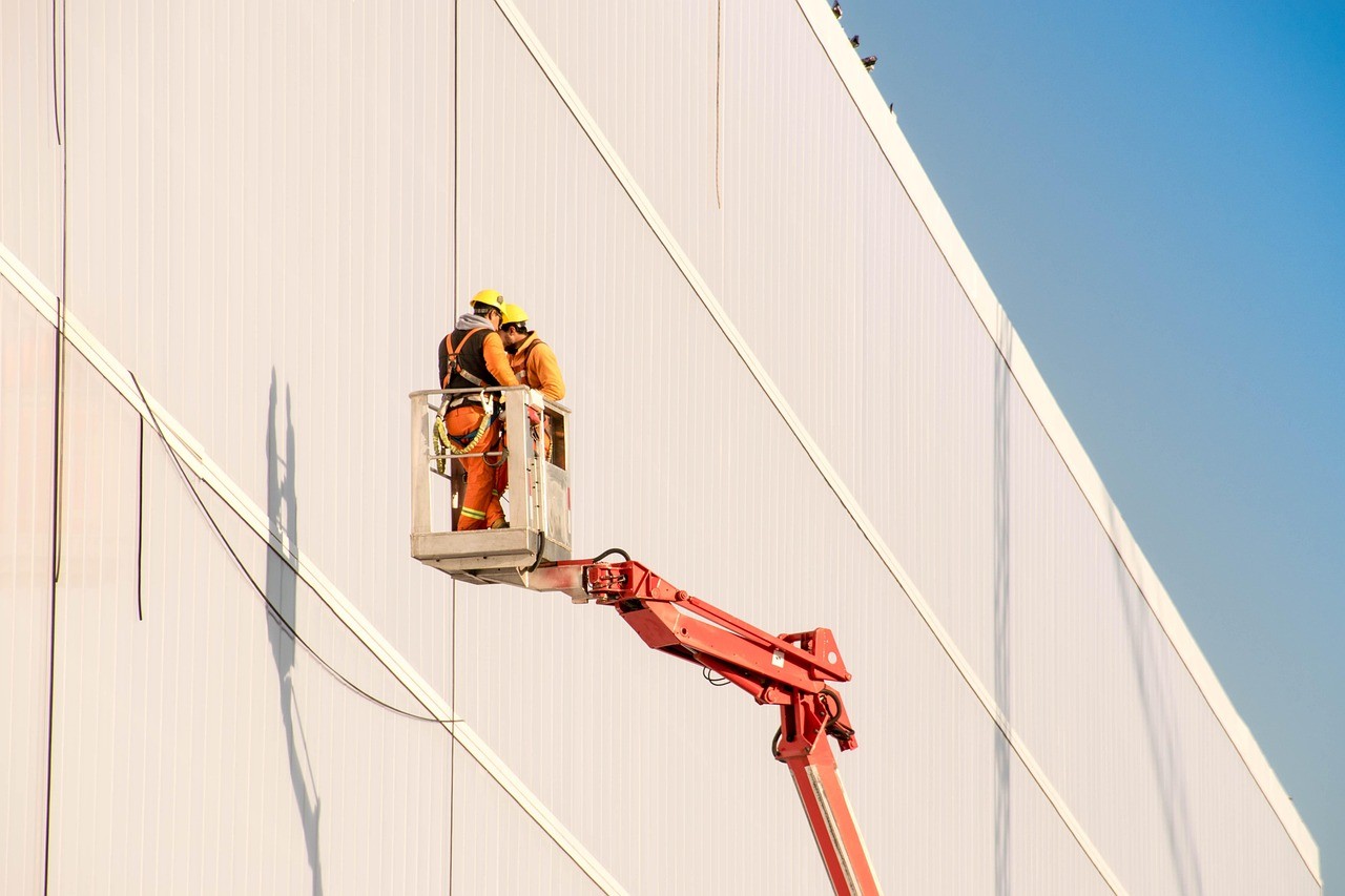 man in white hard hat standing on brown wooden dock during daytime