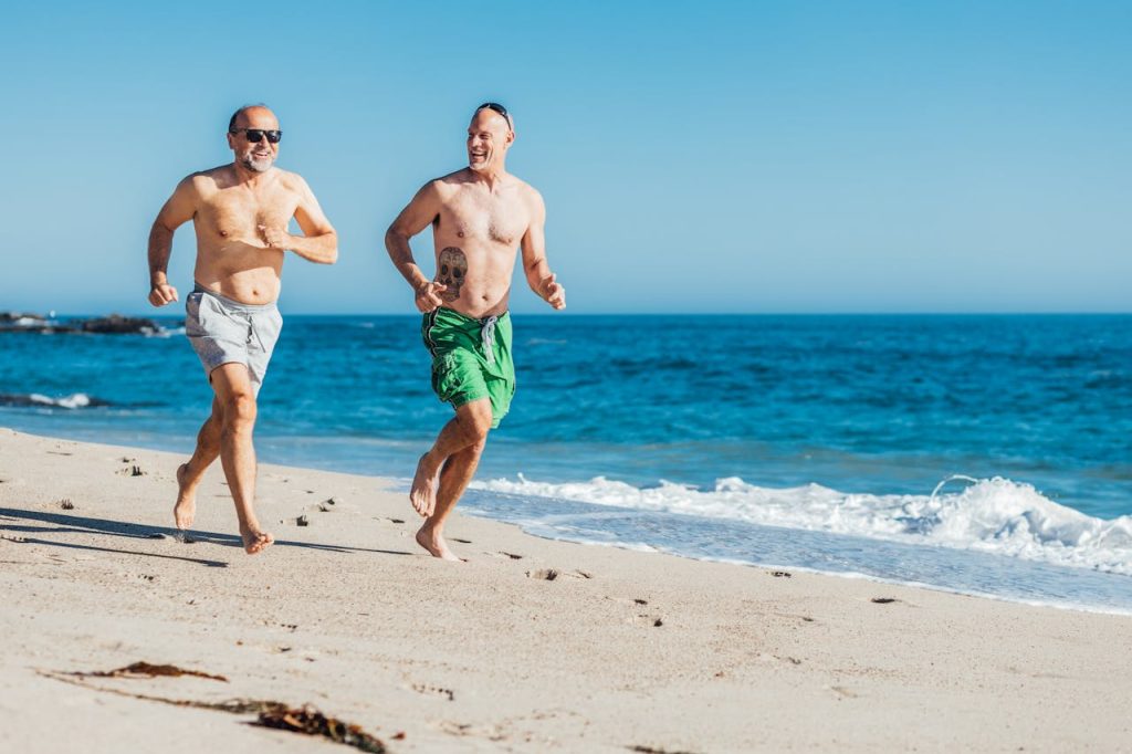 2 males running on the beach