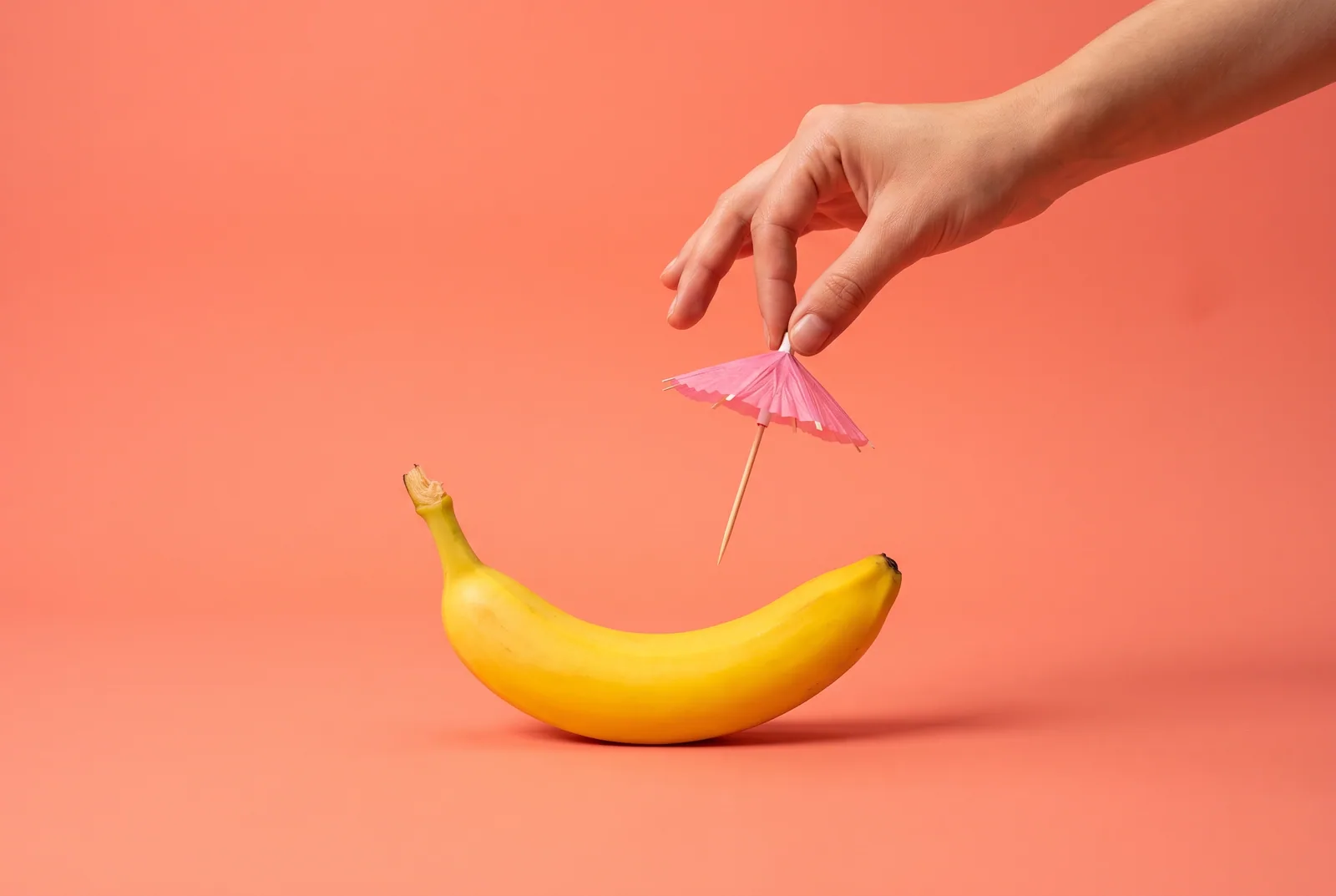 A hand lifting a small parasol off a banana, switching from Canopy to an adult recovery app