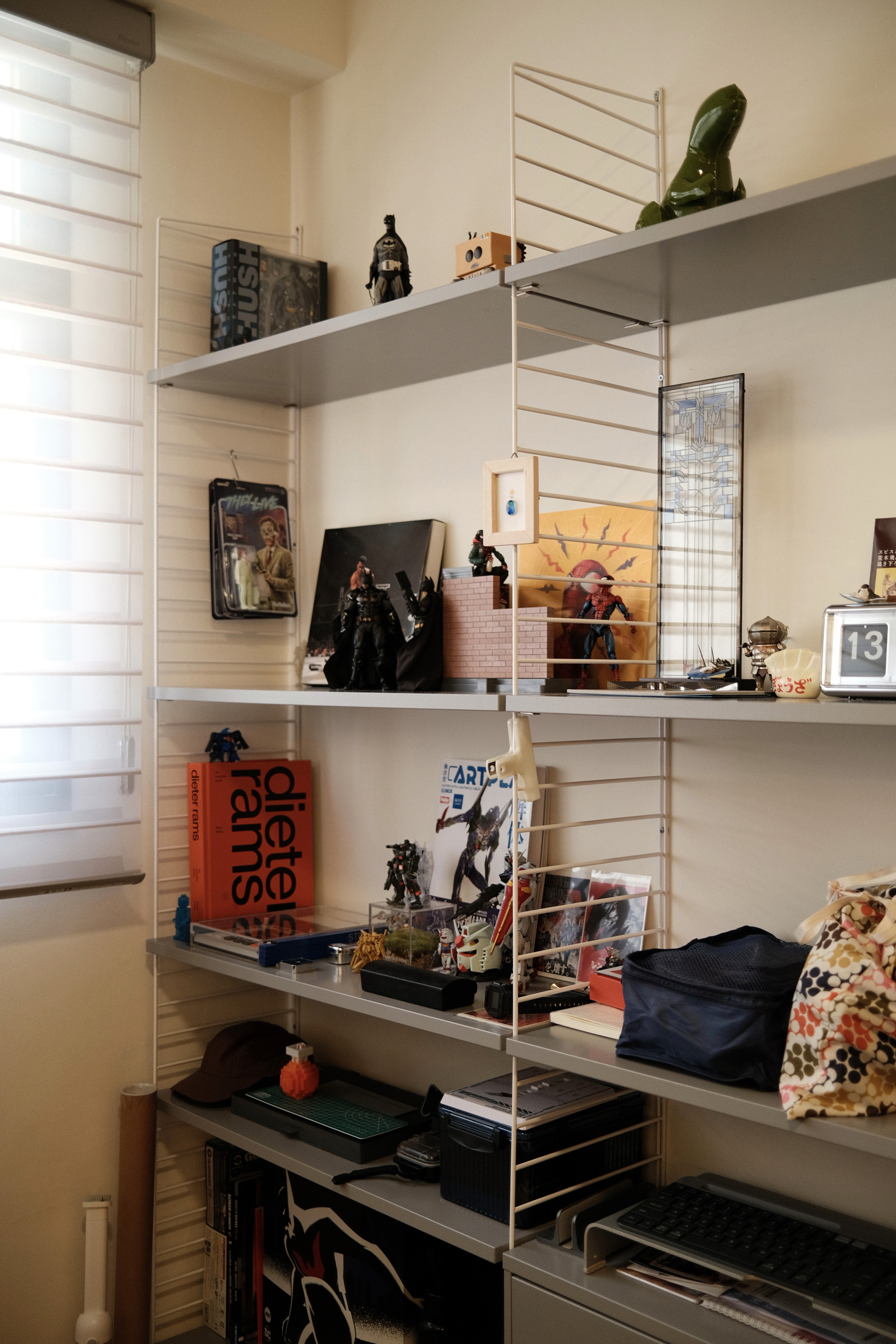 Open shelving transforms storage into a personal display, layering everyday objects, books, and collectibles to reflect individuality within a clean, modular system.