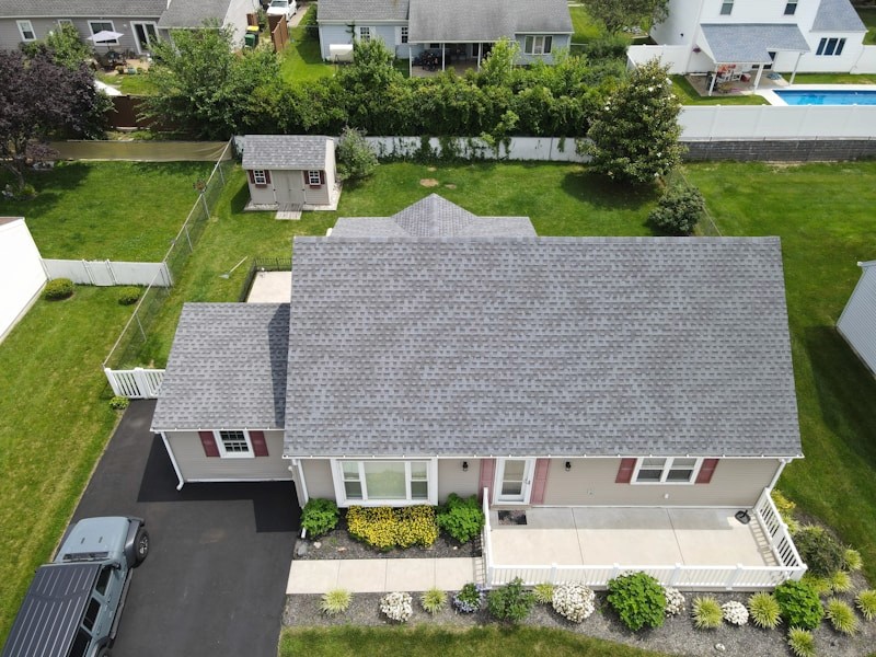 Skylight windows set into a sloped shingle roof, seen from outside