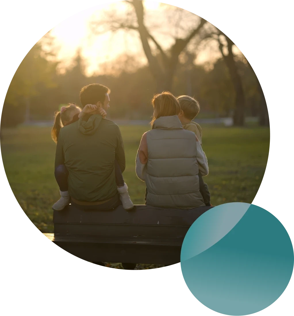 Couple cooking together in a bright kitchen while smiling at each other.