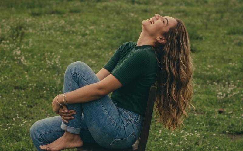 Woman reflecting calmly outdoors during a moment of instinct and self-awareness