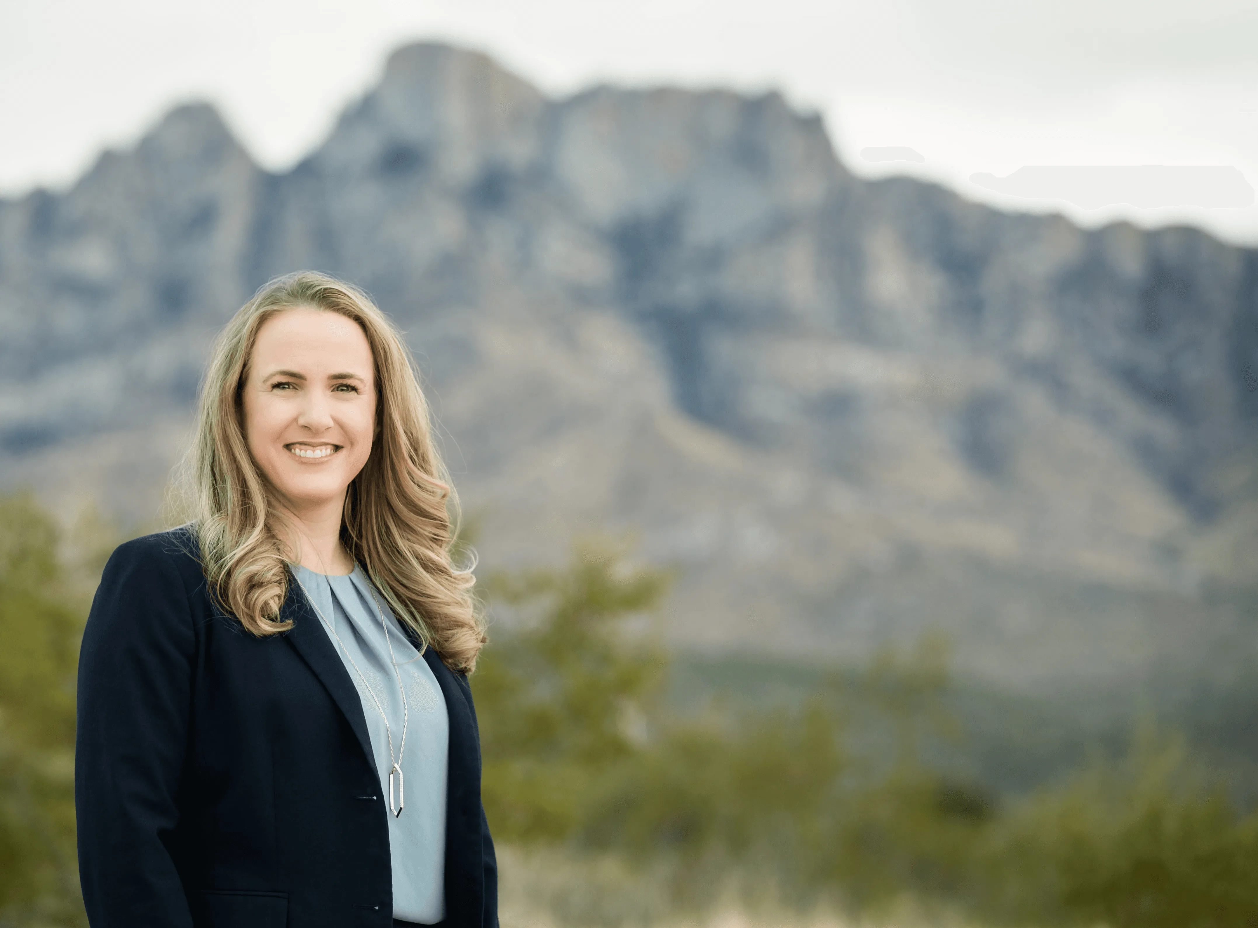 Melanie Barrett for Mayor, standing in front fo the Pusche Ridge