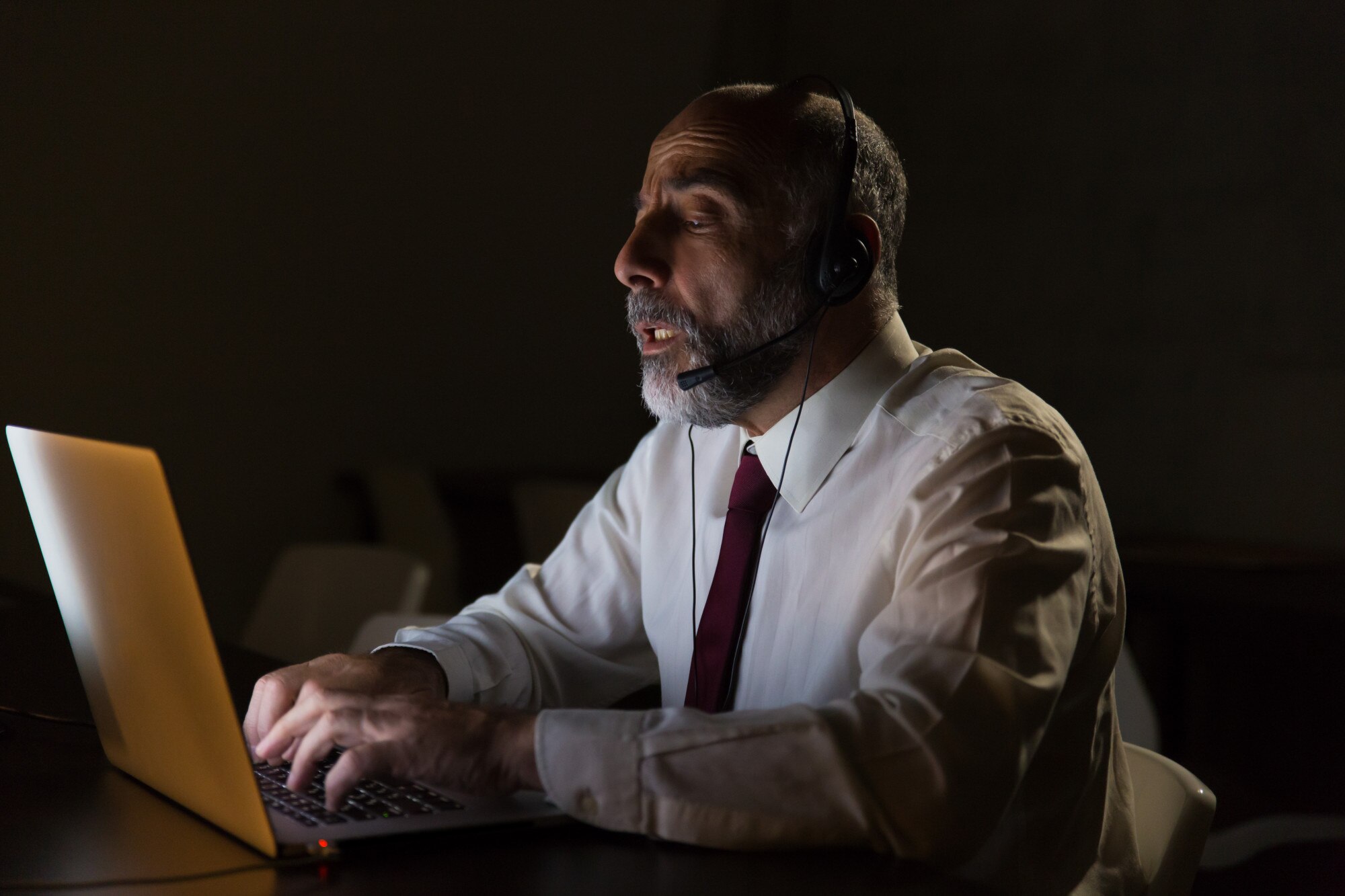 Ondernemer met headset werkt aan laptop, AI chatbot klantenservice voor MKB