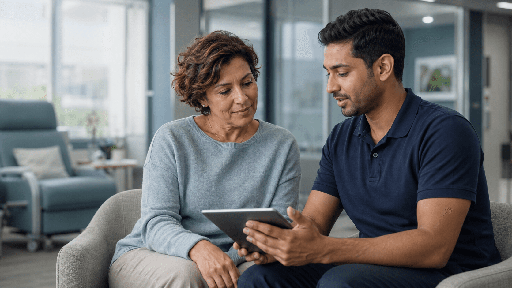 A patient and program coordinator review information together in an outpatient support setting.