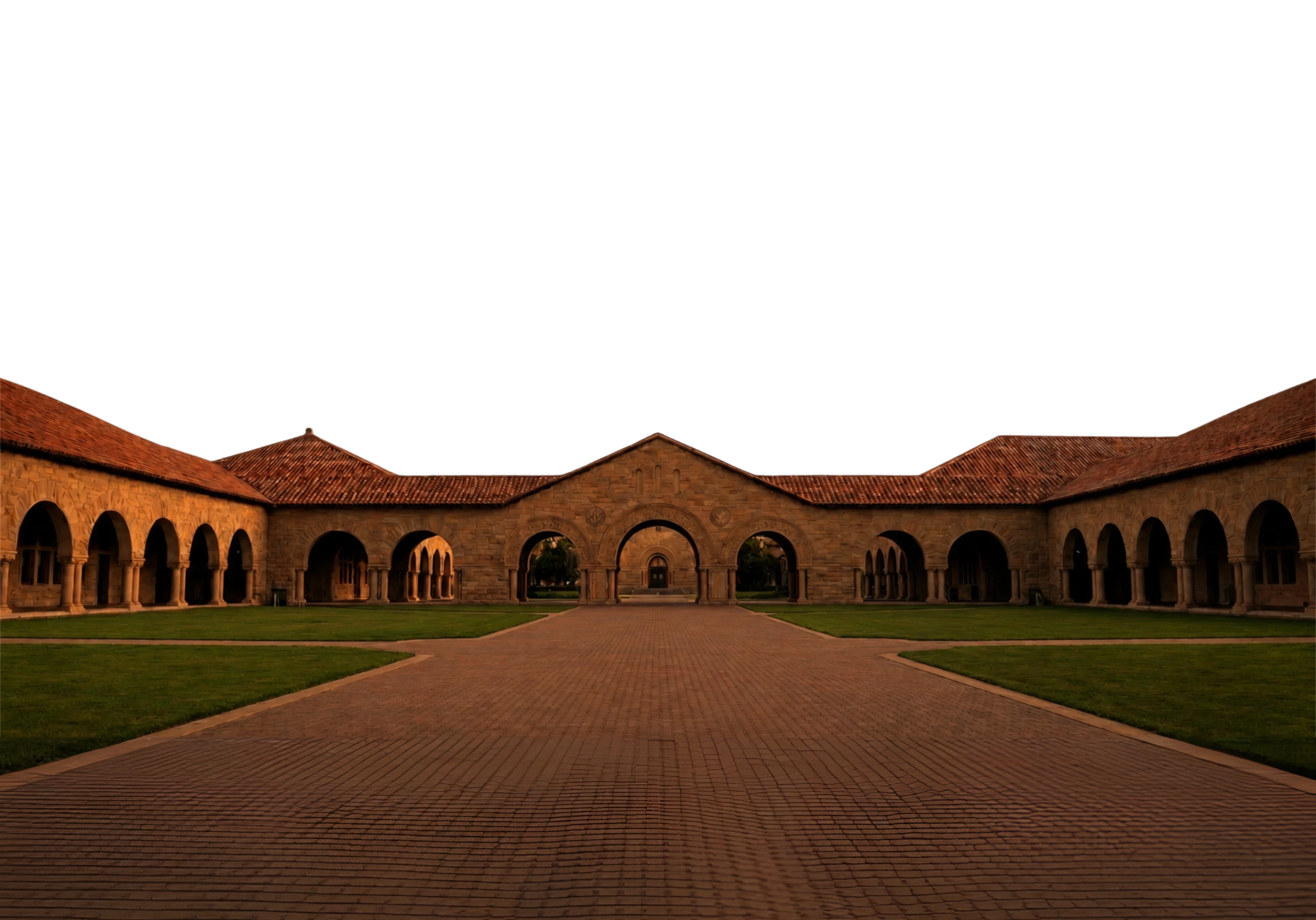 A panoramic aerial view of a picturesque coastal university campus with Spanish-style architecture, featuring terracotta-tiled roofs and beige walls, surrounded by lush greenery and scenic ocean views.