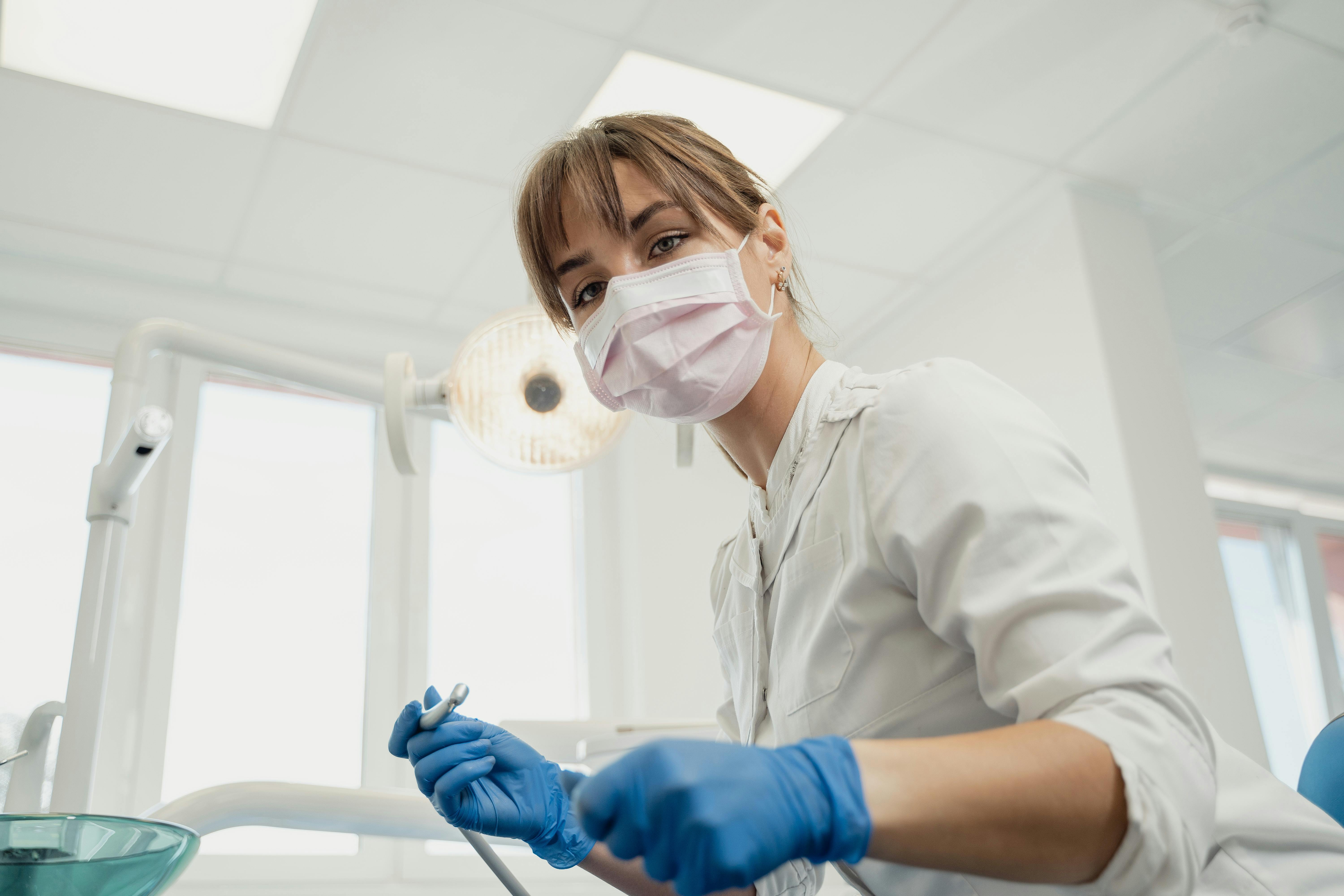 dental hygienist preparing to clean teeth