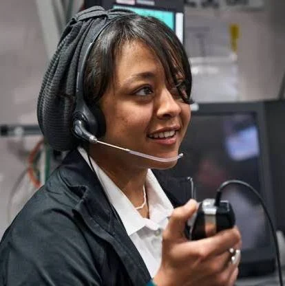 muscular man in glasses smiling and folding arms
