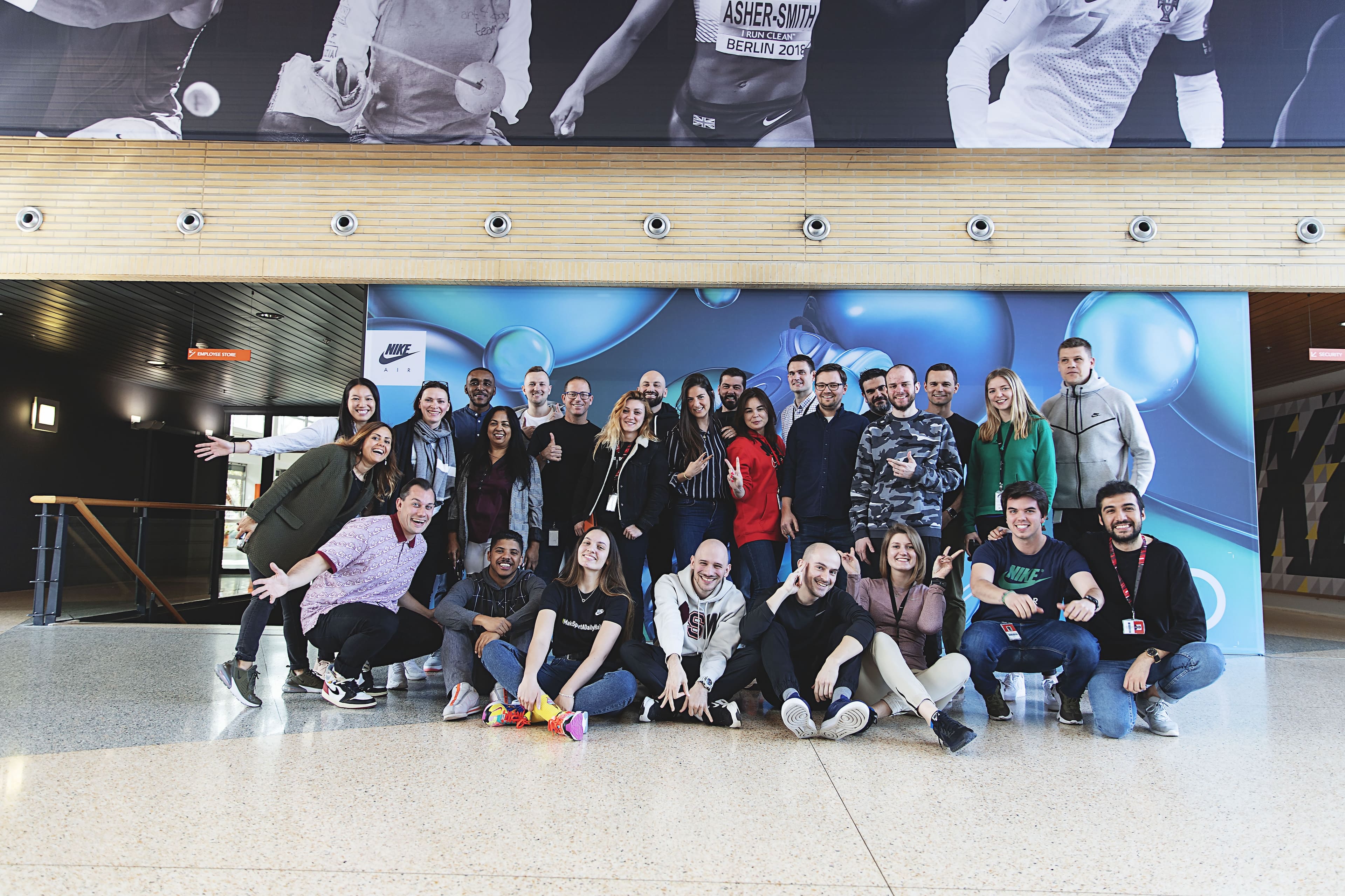 Crowded crosswalk with the sun coming in low over the buildings