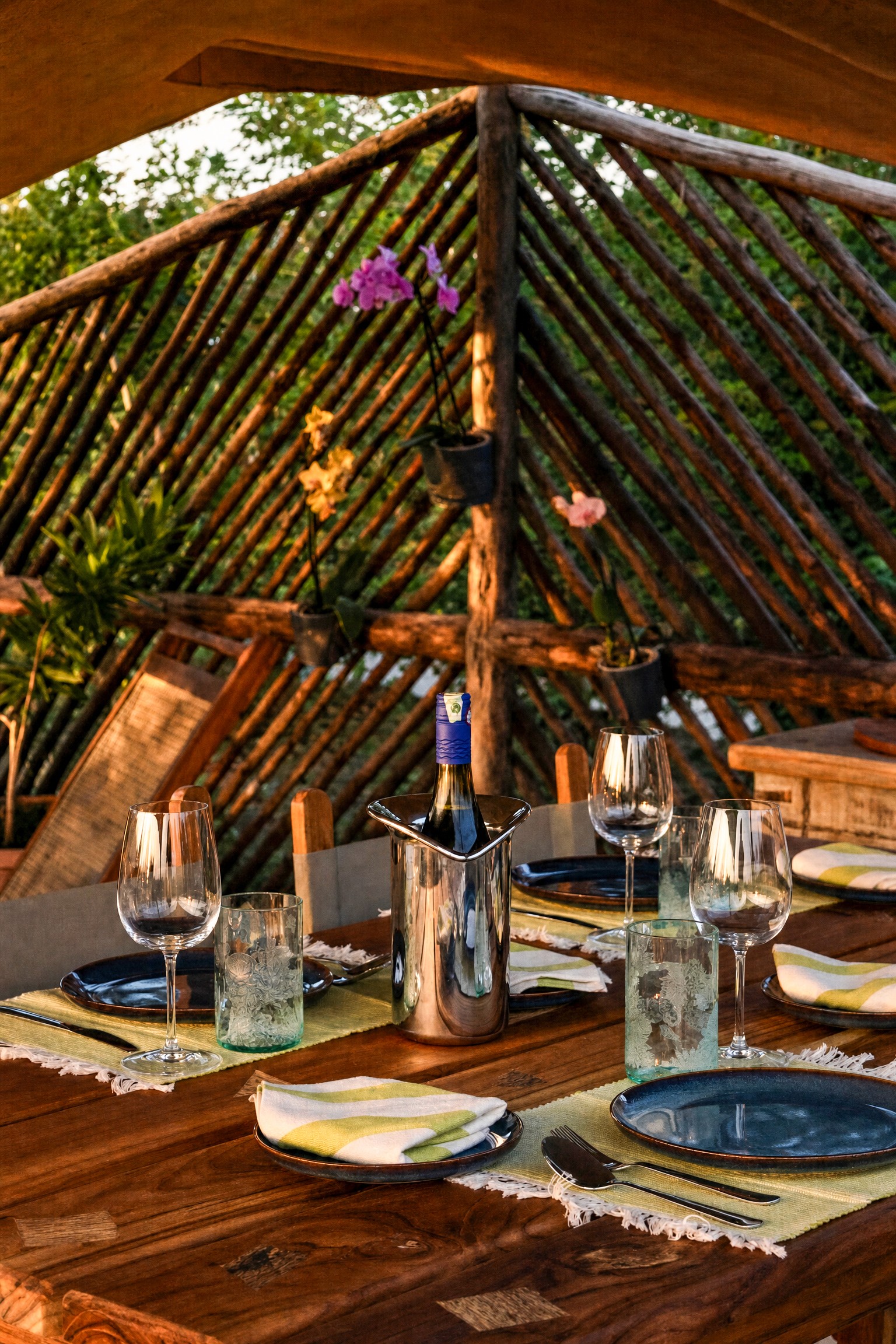 Circular garden lounge with cushioned seating around a fire pit, with a tortoise nearby