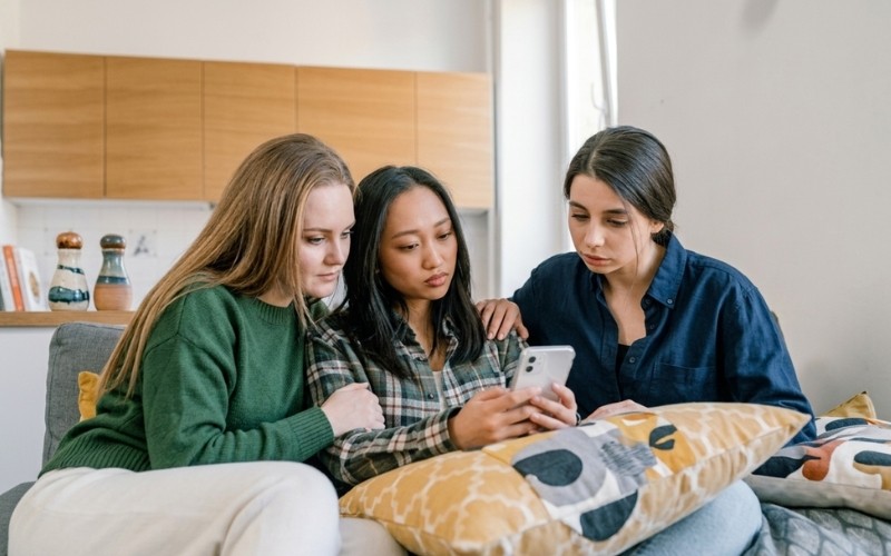 Three women discussing information together during an empathetic conversation