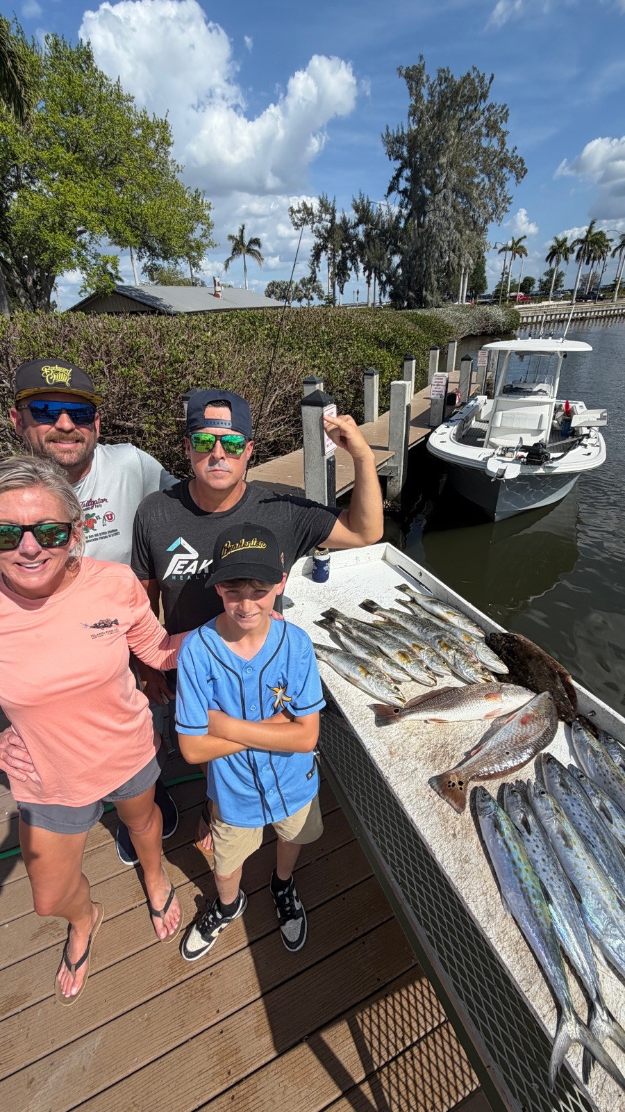 A family at the dock on the Manatee River with the day's catch