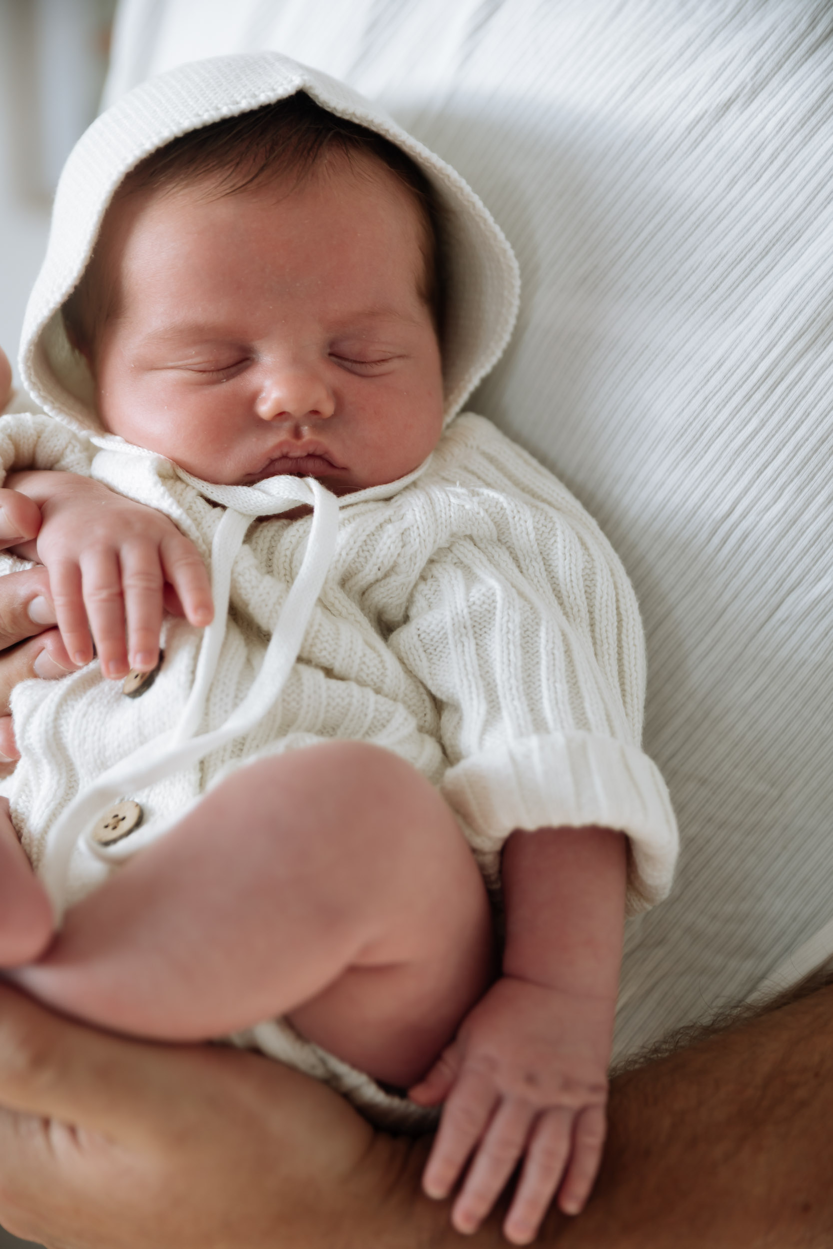 Newborn baby in soft window light at newborn photography session in Mackay
