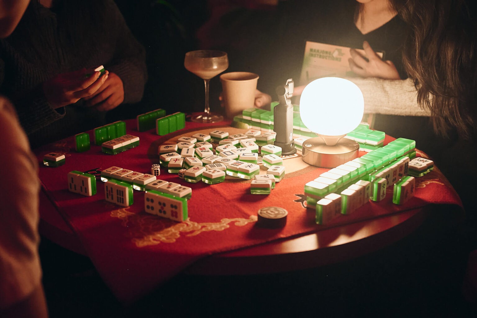People playing mahjong around a table