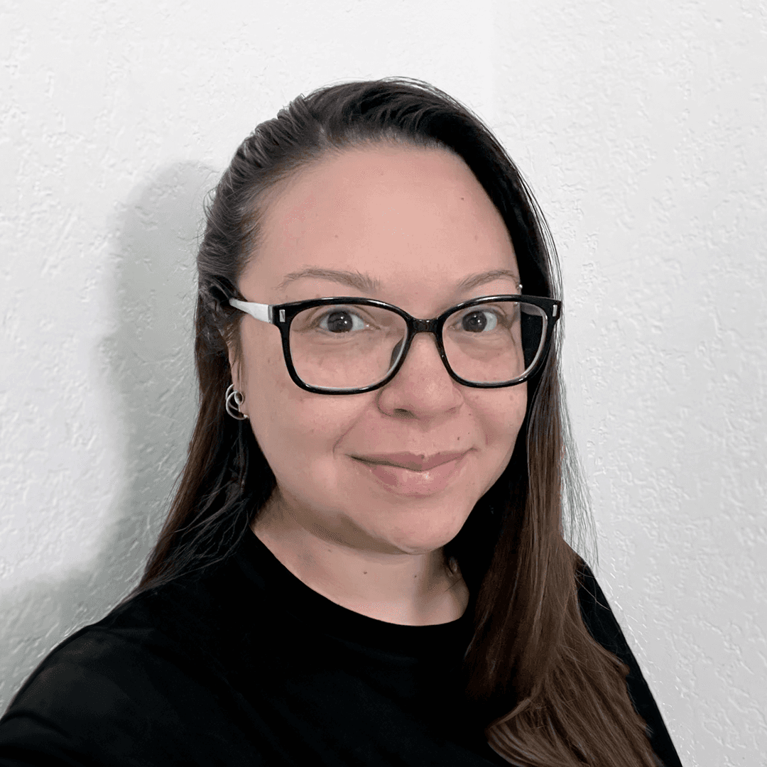 Portrait of Tiffany McKee, Product Designer, smiling at the camera.