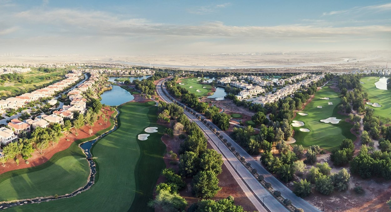Scenic view of the golf course at Redwood Park, a luxurious golf resort in Dubai, featuring lush greens and palm trees.