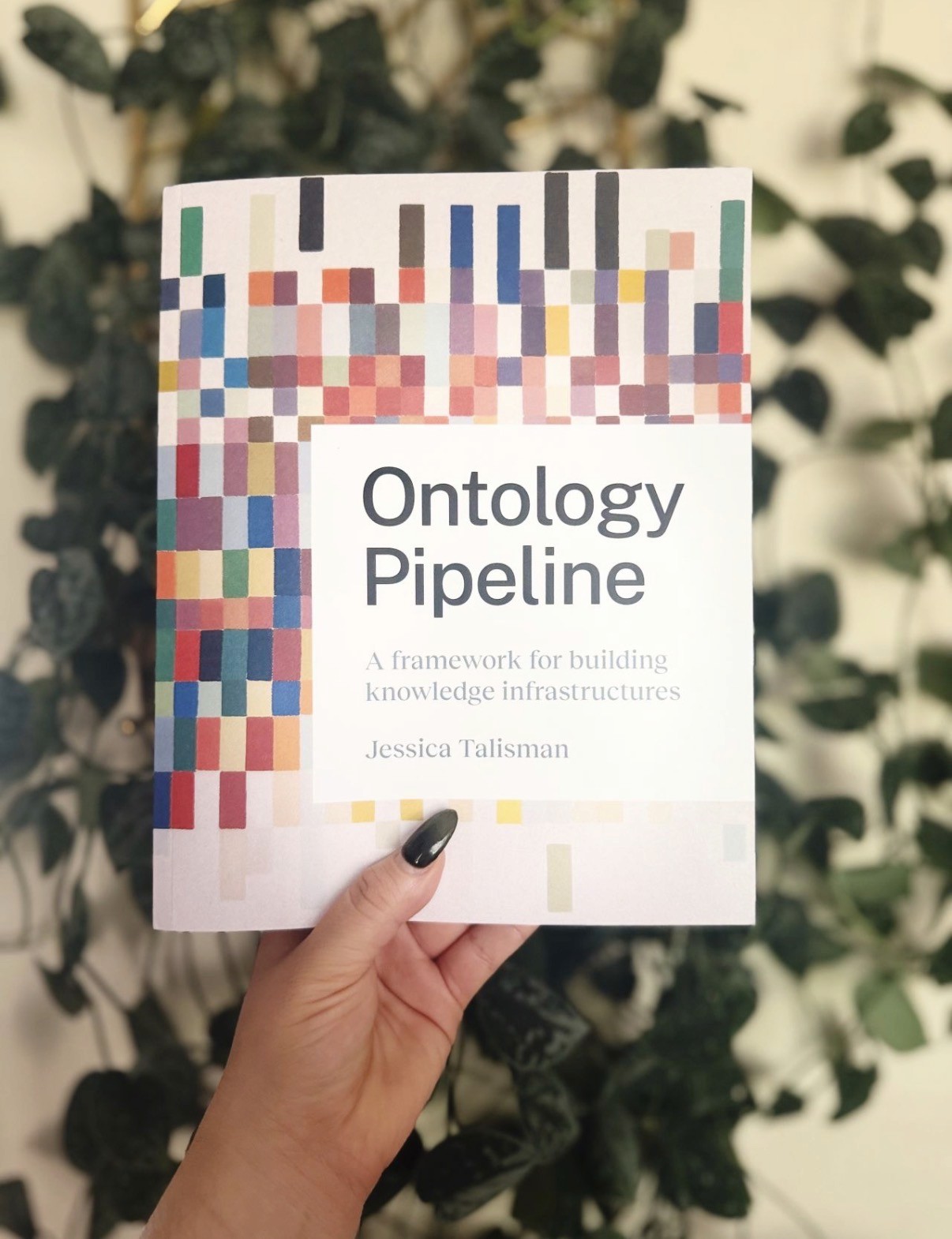 A hand holding the cover of Ontology Pipeline by Jessica Talisman.
