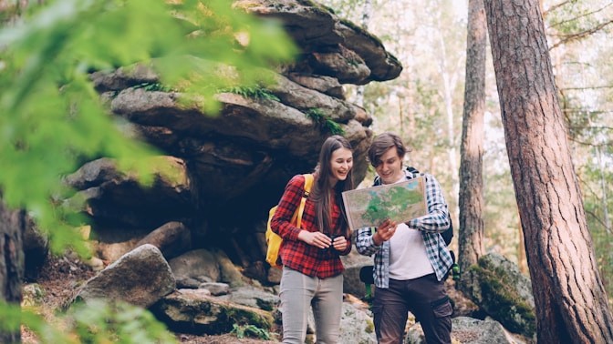 Two adults exploring a wooded trail together