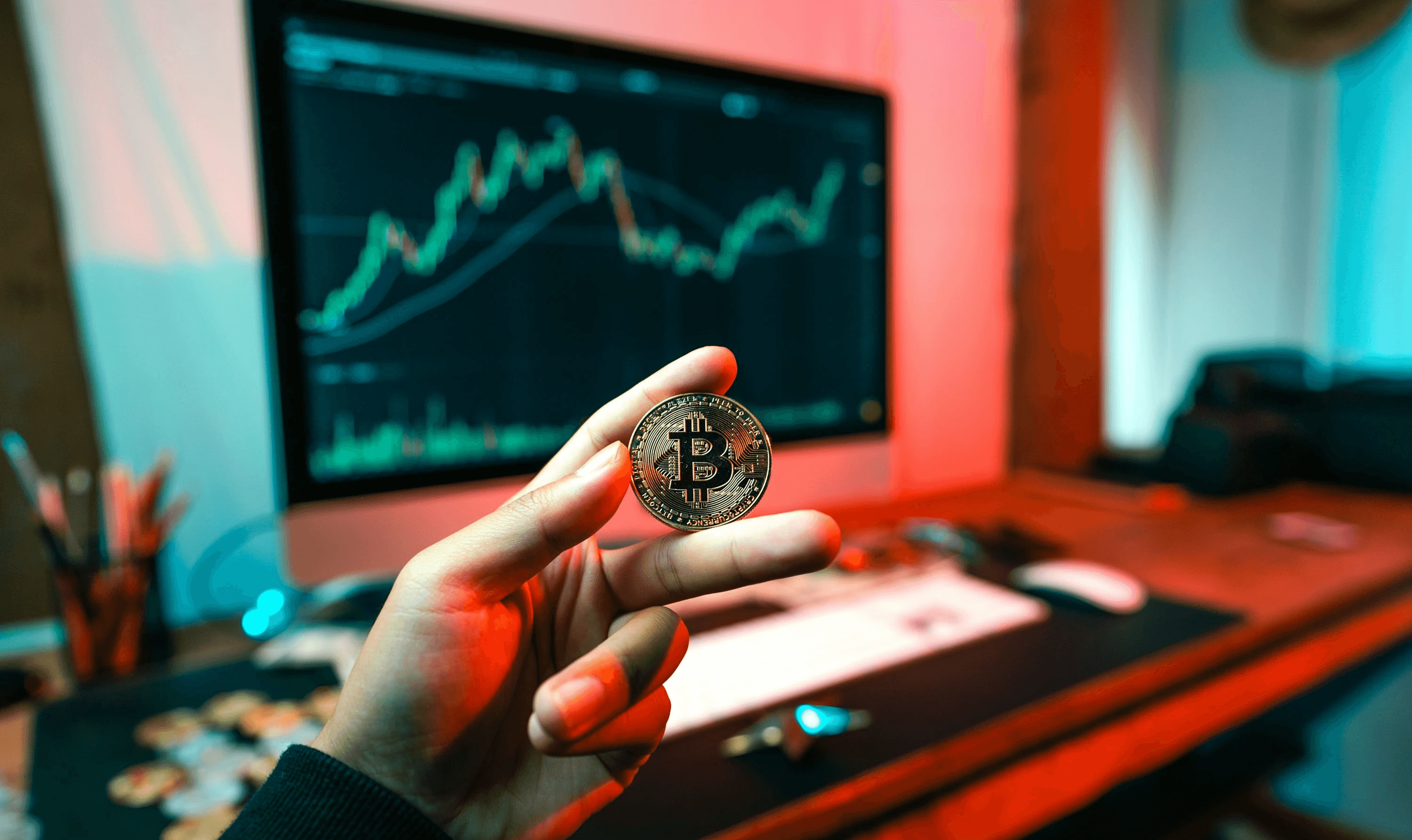 Man holding a Bitcoin coin - How to Buy Crypto Before Listing
