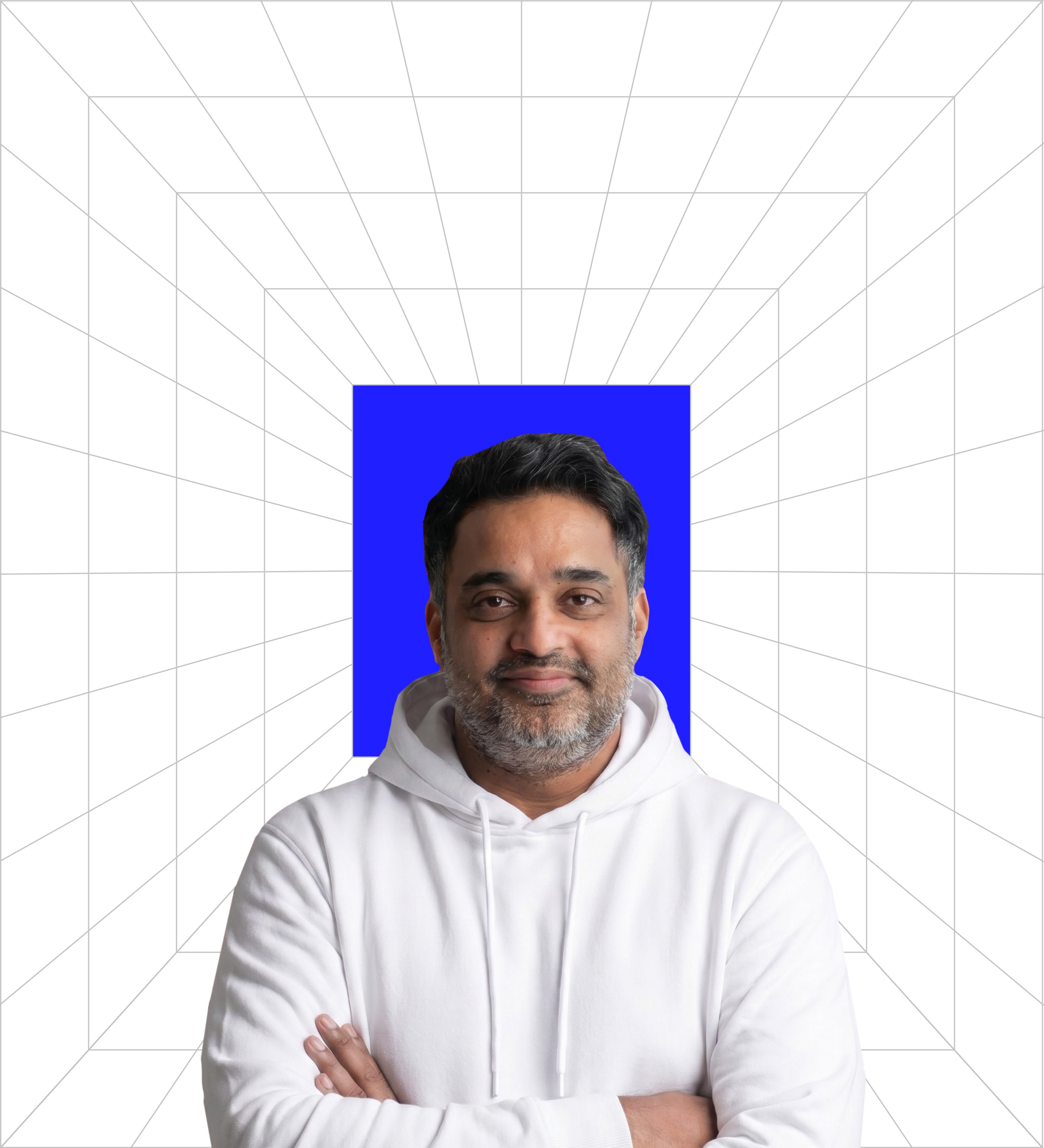 usuf Merchant, BMEG Country Head for OOH & BTL, posed with crossed arms, wearing a black hoodie and a professional smile. He is set against the signature blue background and a geometric grid pattern, embodying experienced and innovative operational leadership.