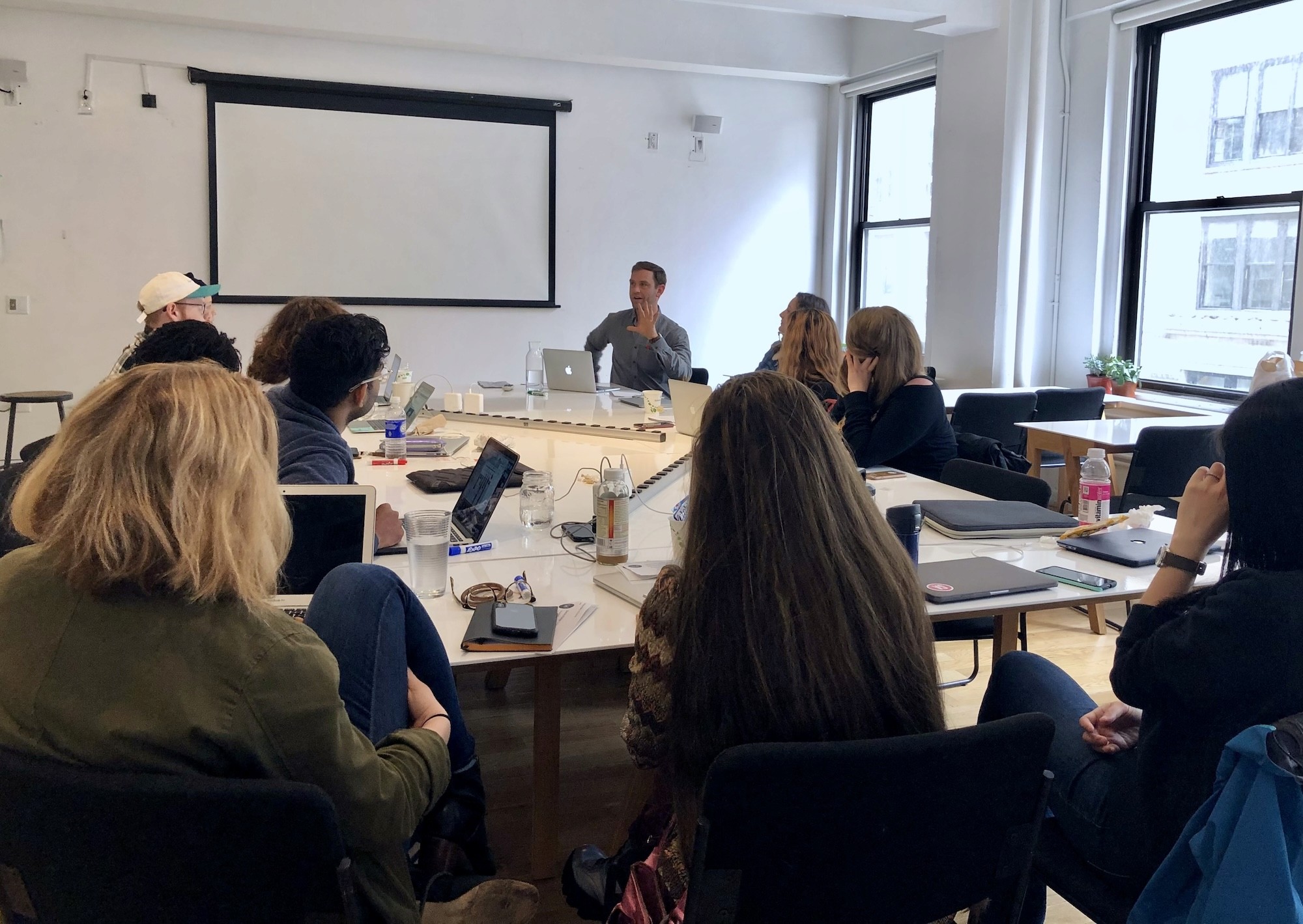 A learner in a design studio, engaged and seated at a laptop during a session.