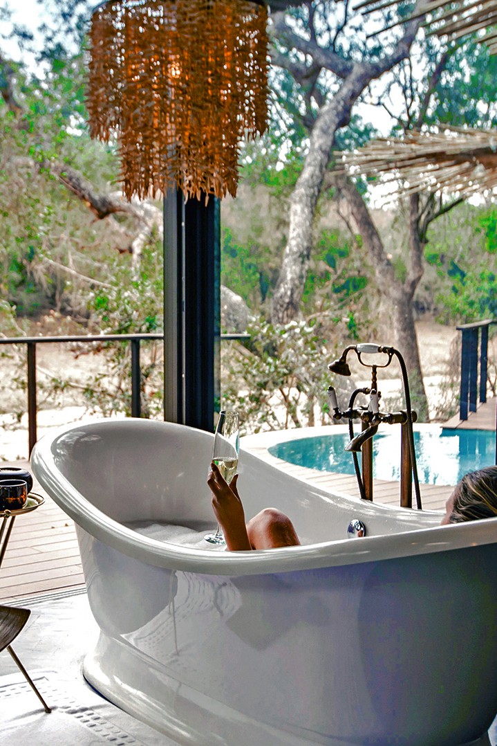 Soaking in the bath with views of the Mabrak river at Dulini Moya, Sabi Sand Reserve, South Africa