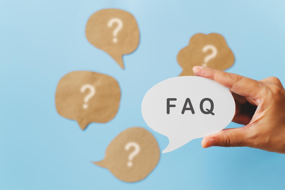 A person checking a laptop with paperwork nearby, symbolizing USCIS processing and case tracking. Form I539