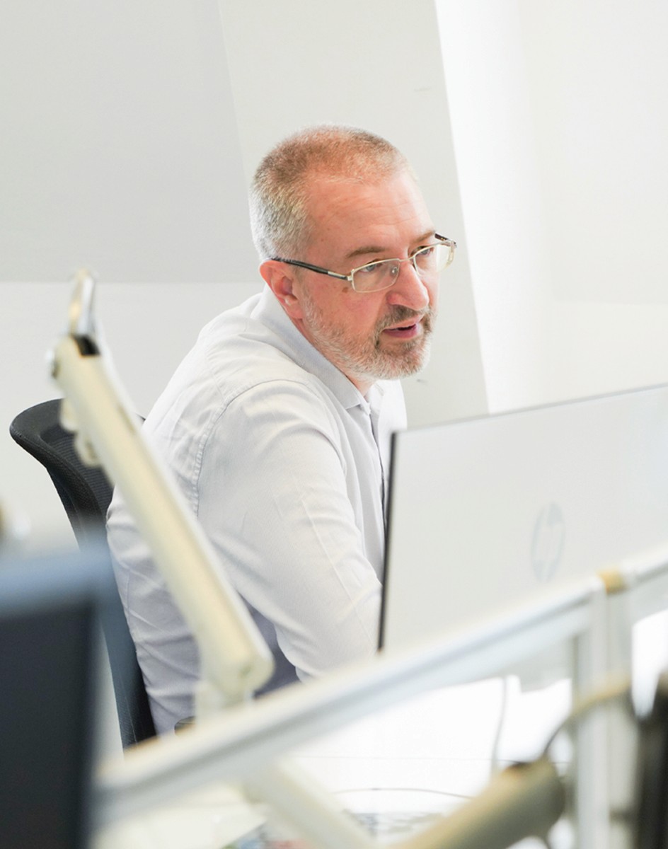 Composite image of the Hughes Price Walker pension support team working in the office.