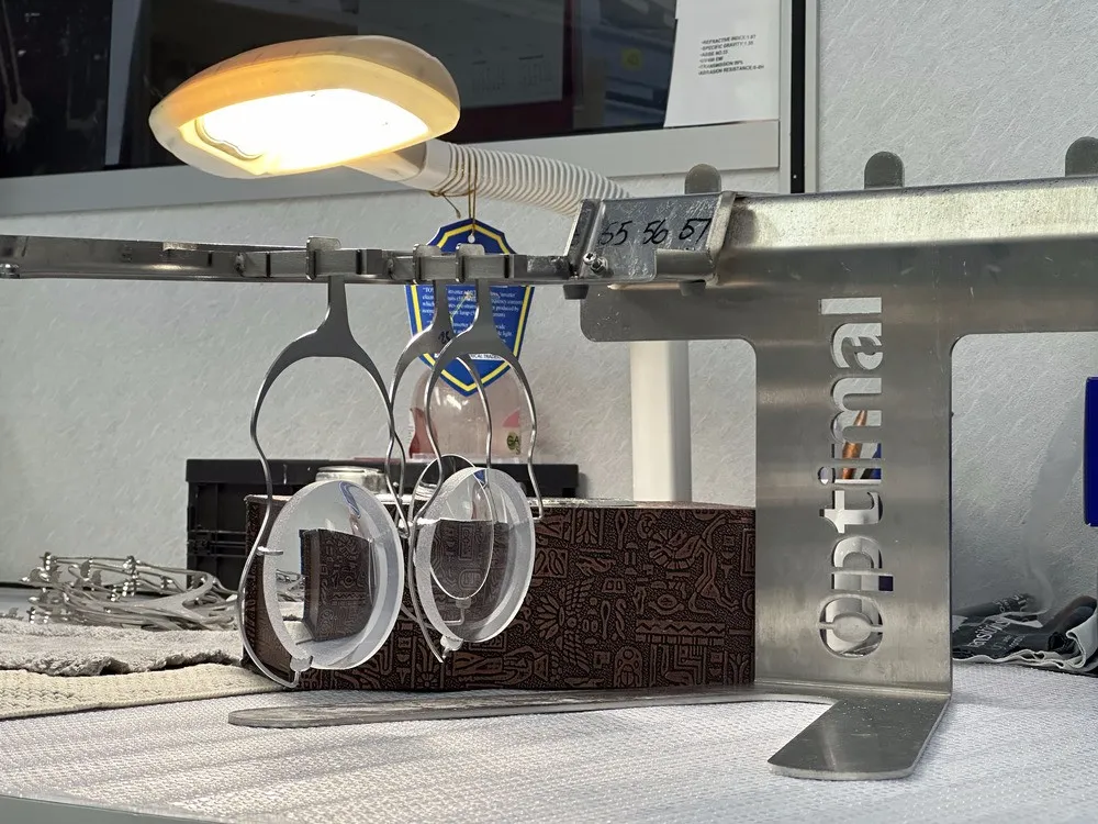 Lens rack holding multiple lenses on a desk