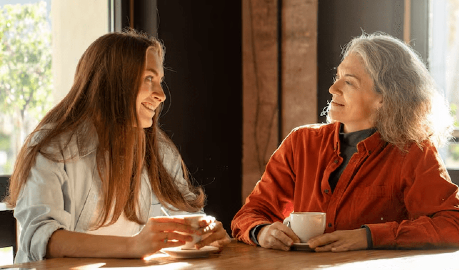 two woman sitting and talking