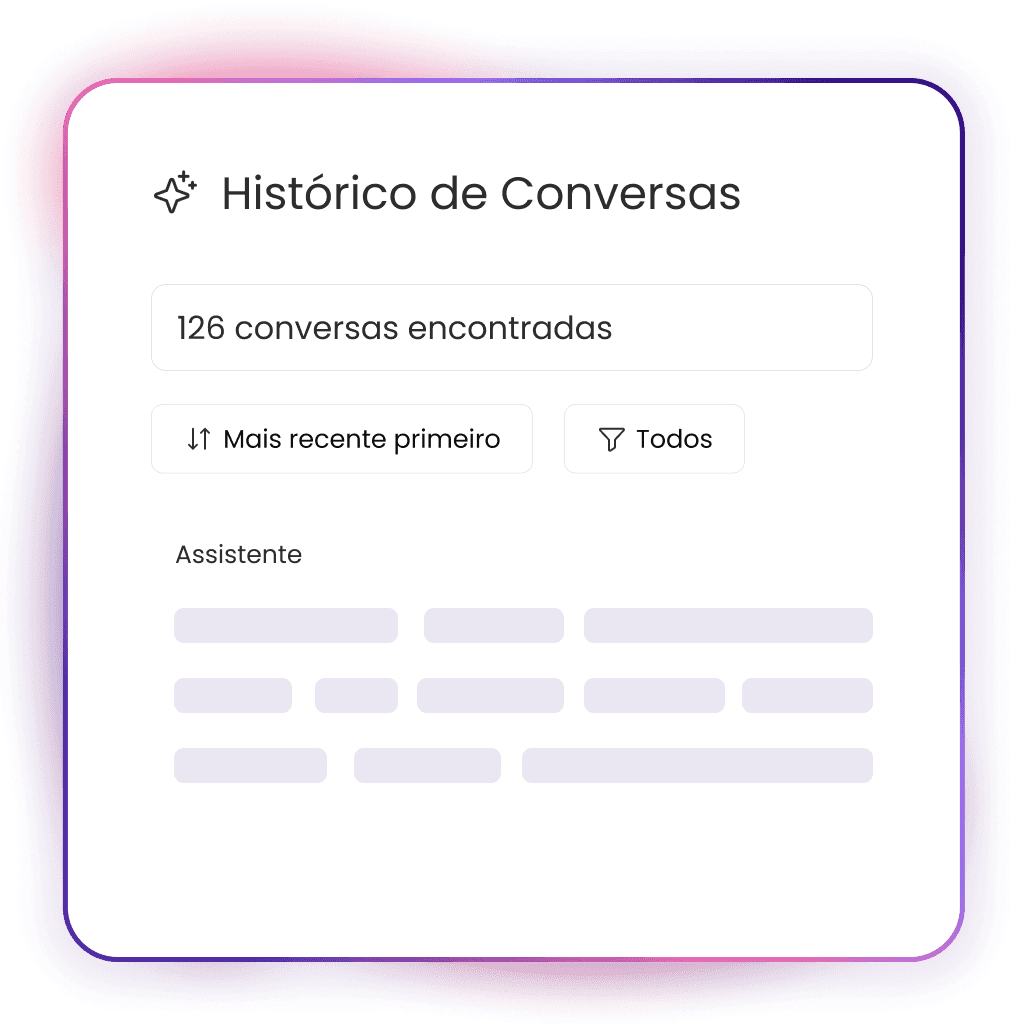 A young person with curly hair smiles at the camera while sitting in front of a laptop against a dark background.