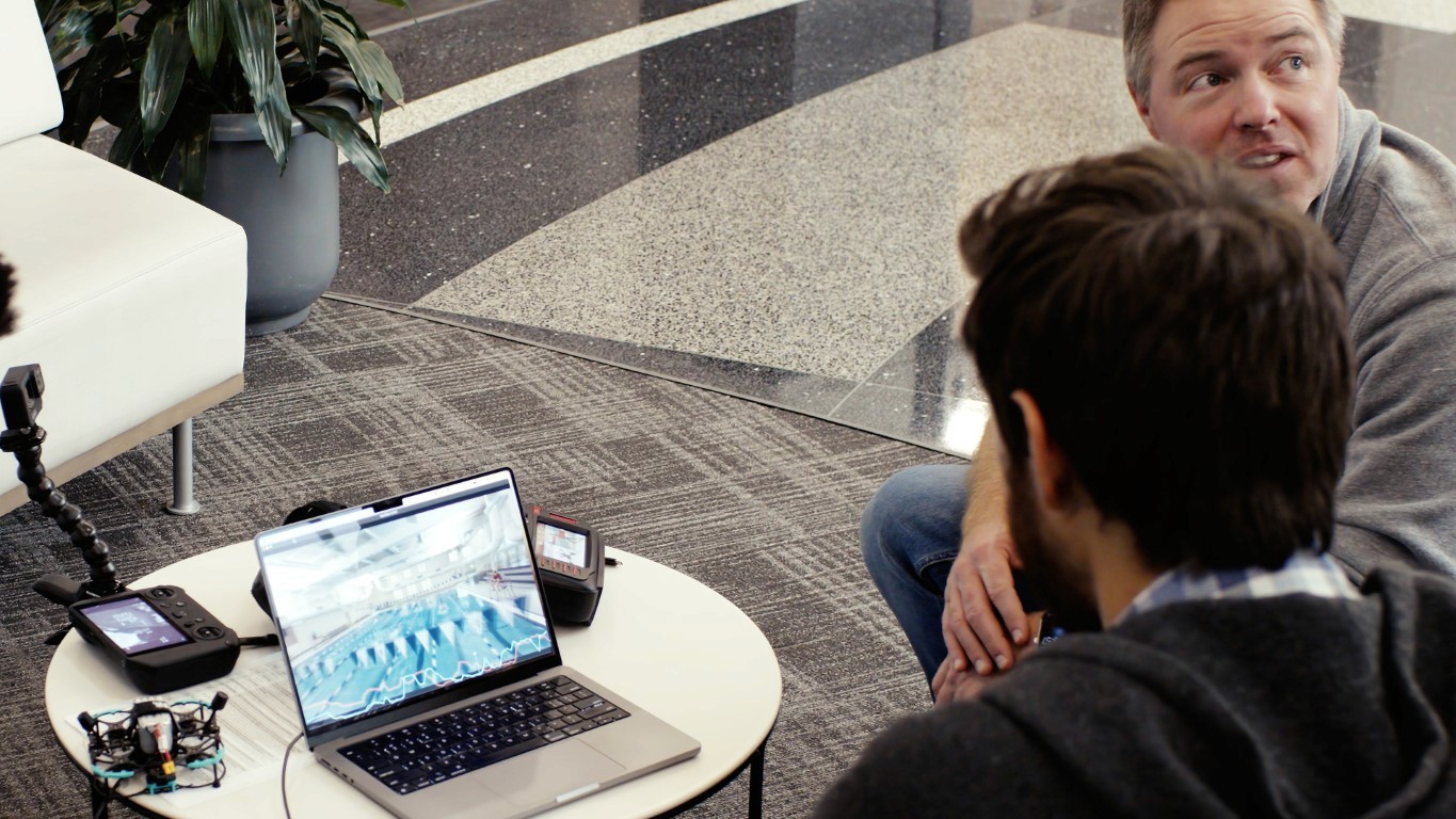 Modern bathroom featuring wooden cabinetry, a bathtub, a sleek sink, and natural light from a window.