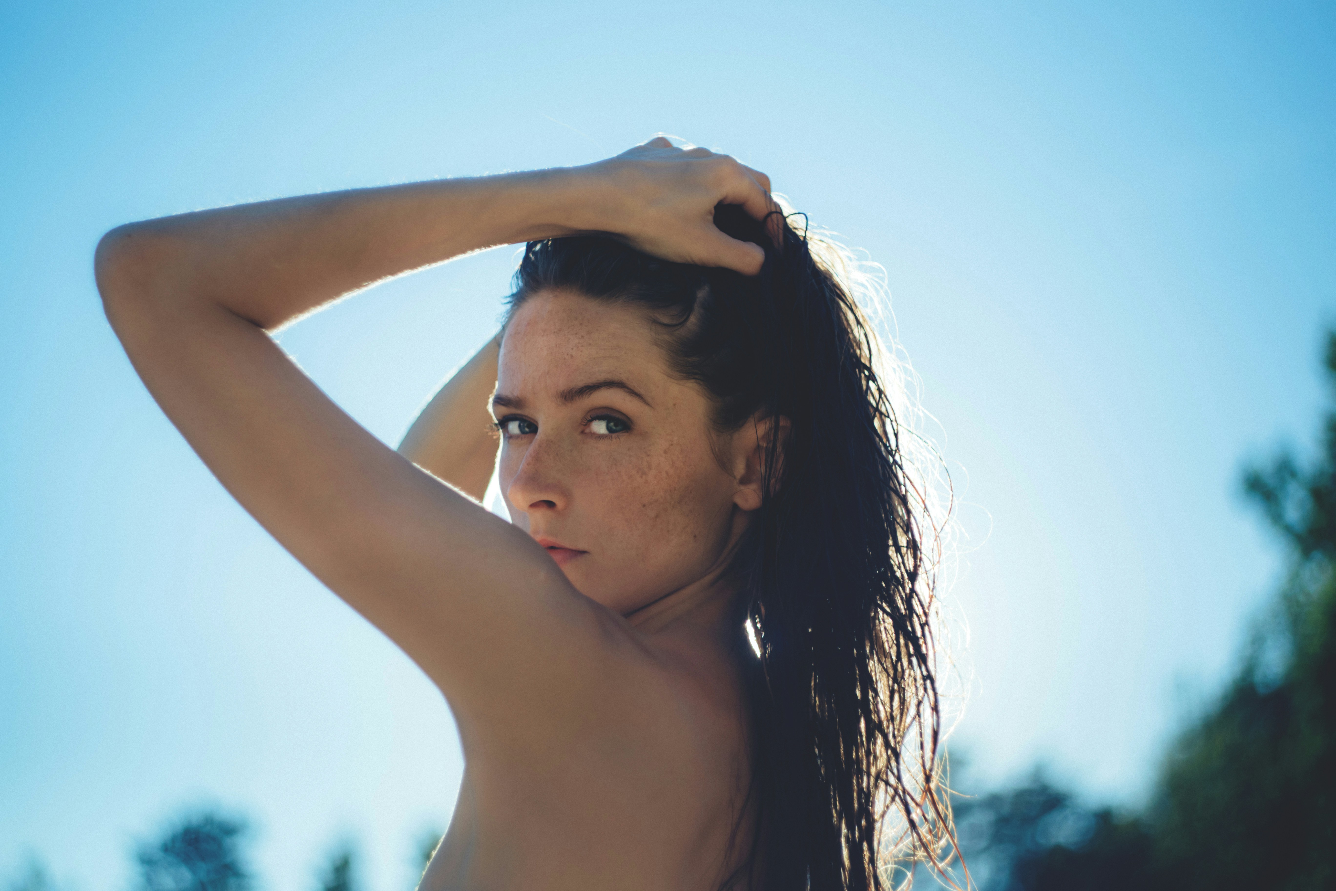 woman at a beach - What Colors Look Good on Tan Skin