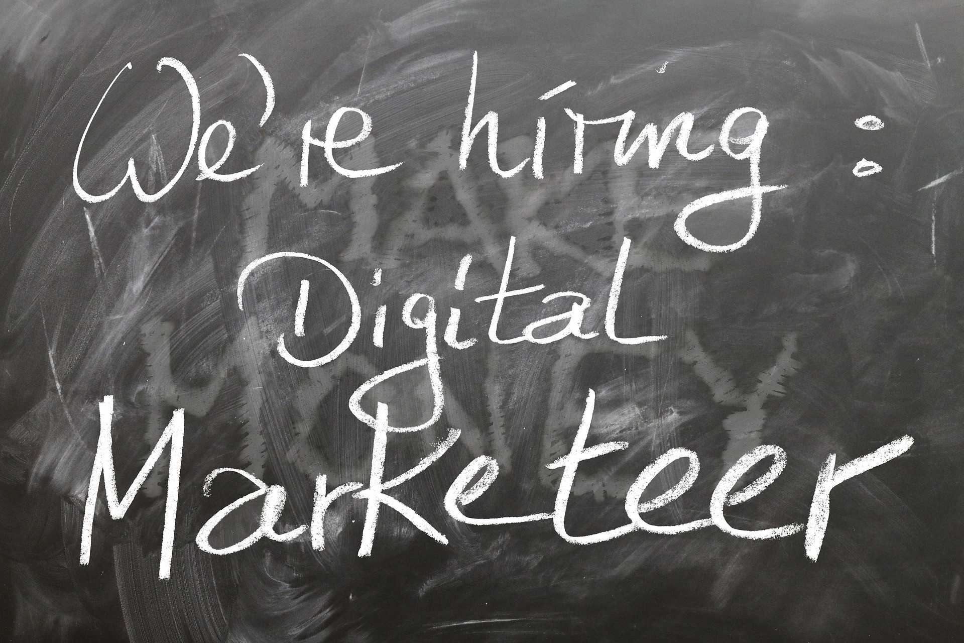 Black chalk board with we are hiring digital marketeer on it