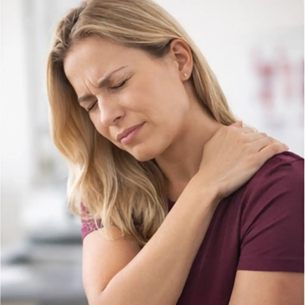 Chiropractor examining a male patient with shoulder pain during a treatment assessment in Draper, Utah