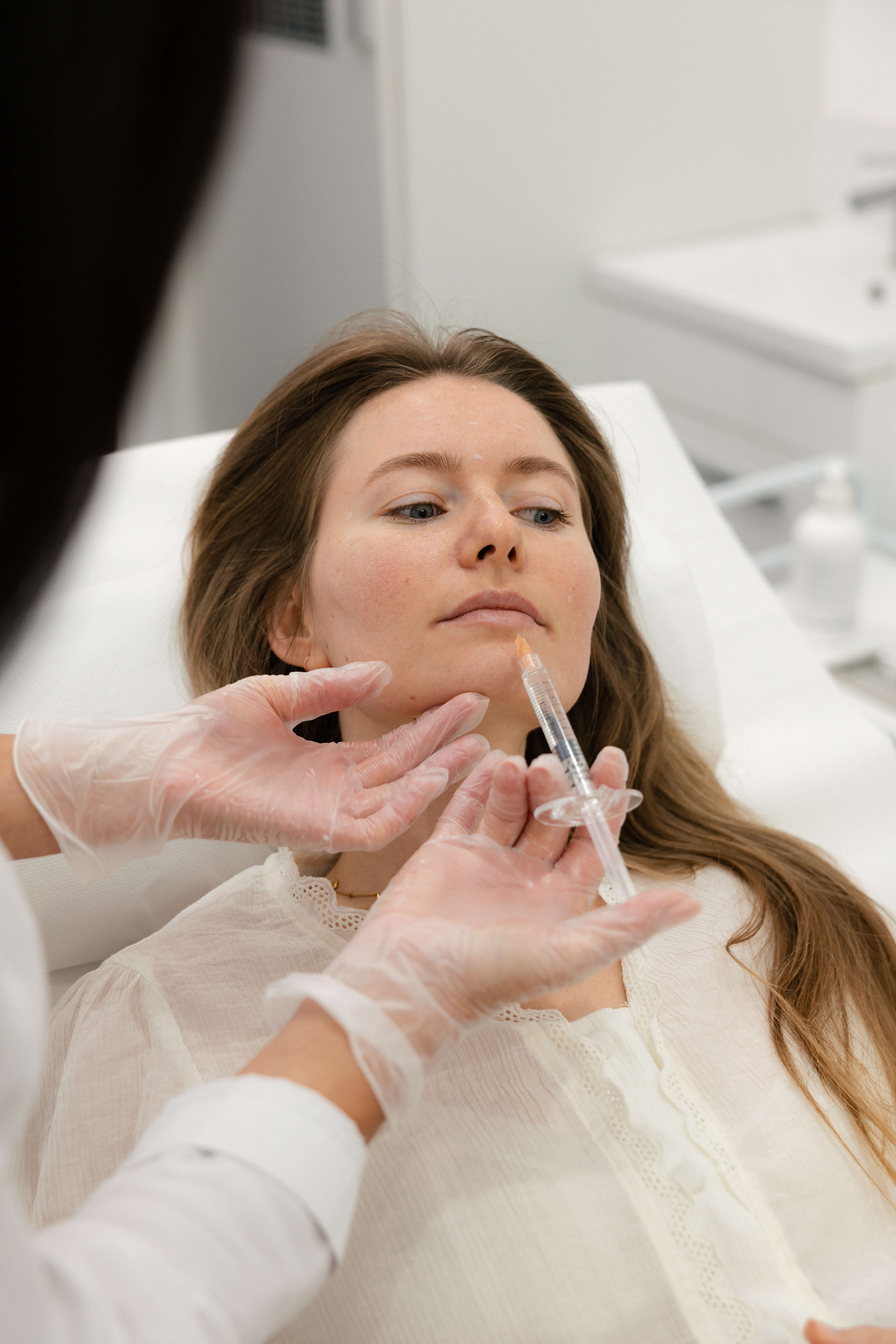 Client receiving an injectable aesthetic treatment at SIGMA Skin Clinic.