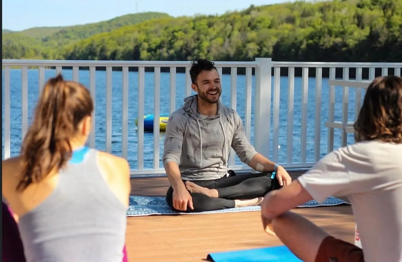 Yoga session on the lakeside deck during a retreat at Camp Lenox