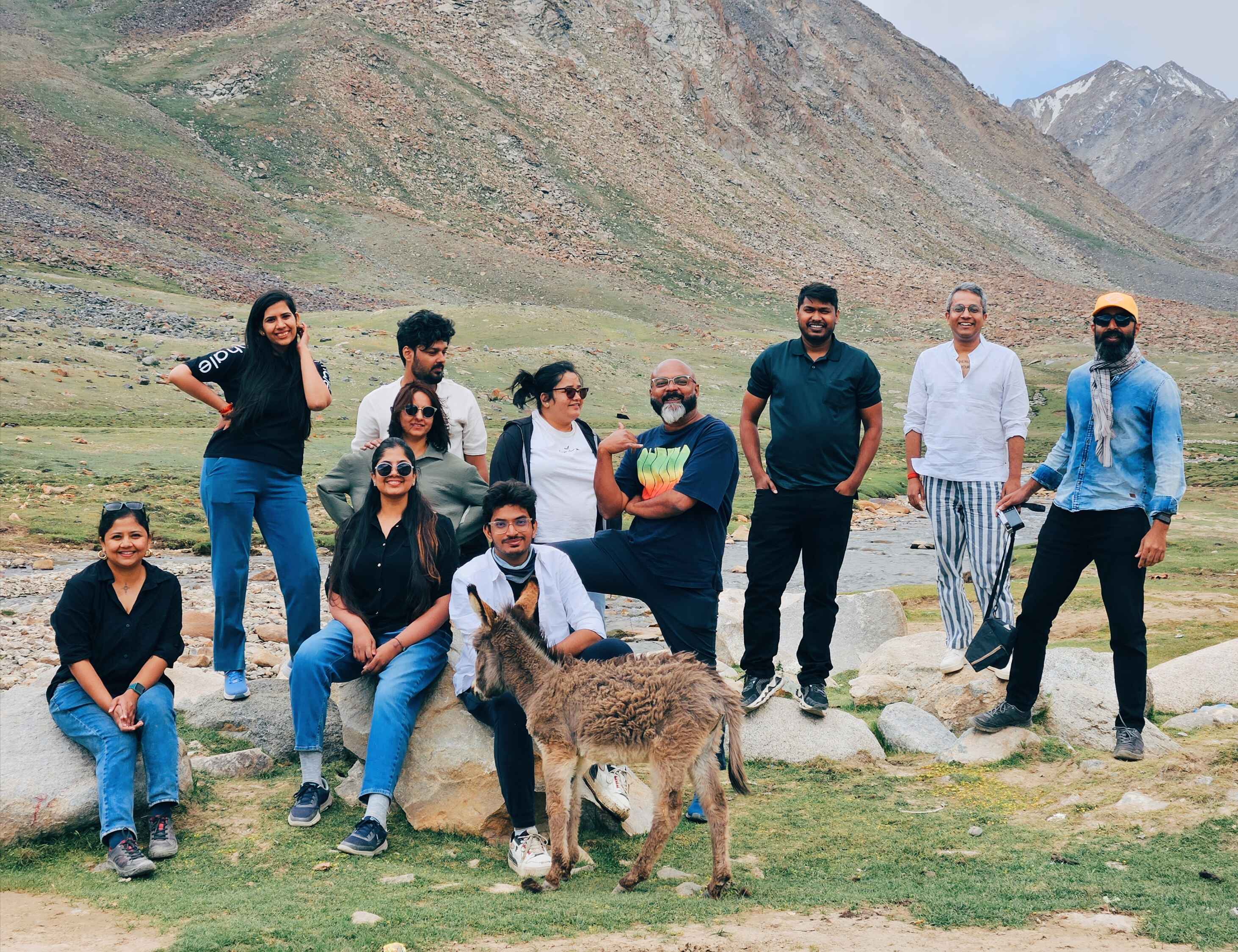 red train travelling near body of water